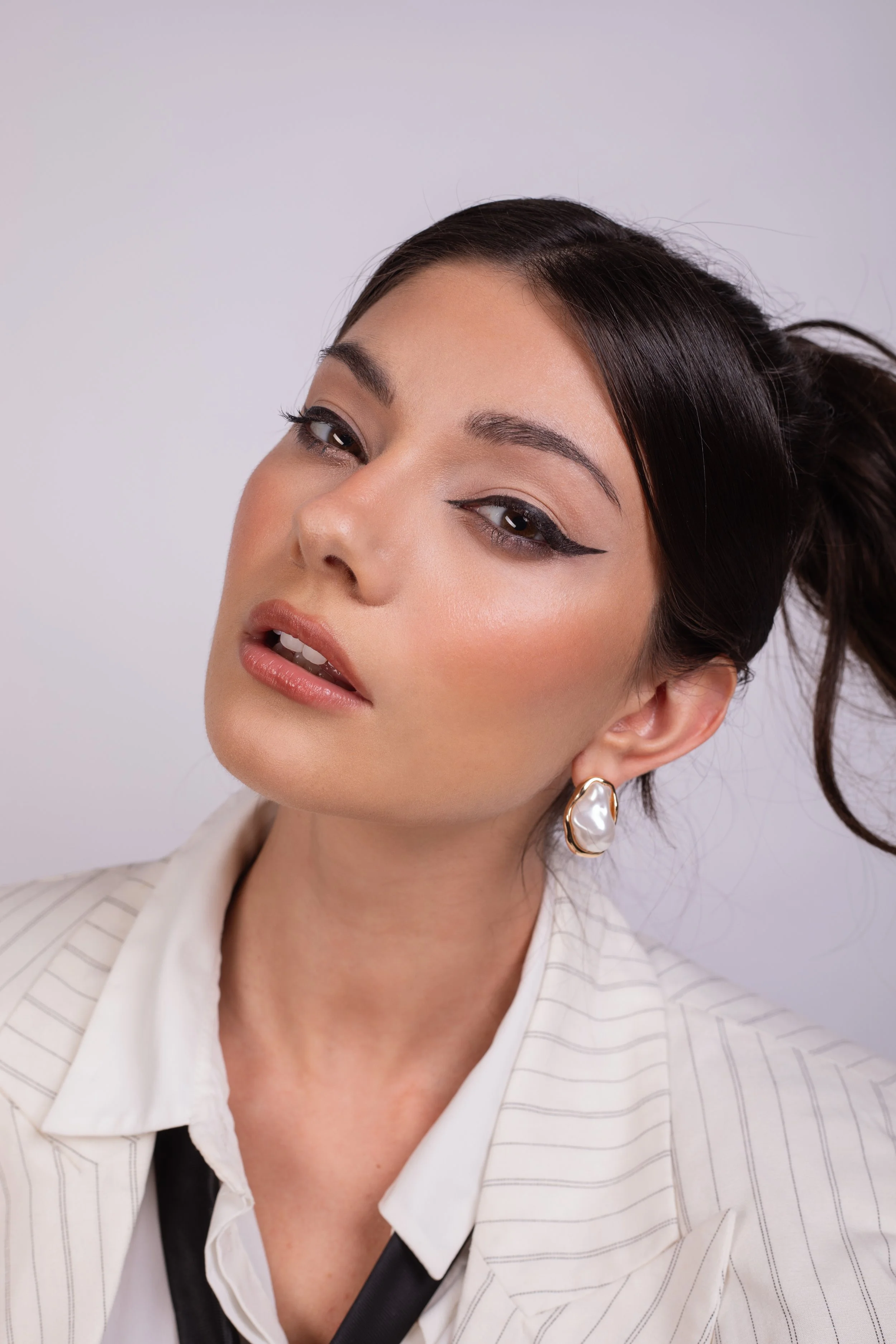 Pippa of London beauty Campaign. Dramatic eyeliner and sculpted skin with modern detailing. Applied with care and precision by Kinga, showcasing clean skin, sharp definition, and professional beauty application. Ideal for brand campaigns.