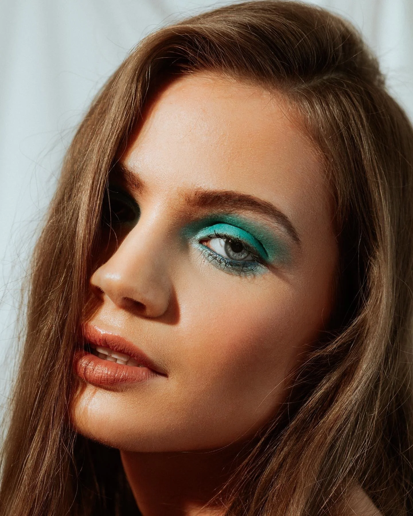 Modern use of colour in makeup. Blue eyeshadow with soft focus skin work. Editorial beauty by Kinga for commercial and beauty imagery