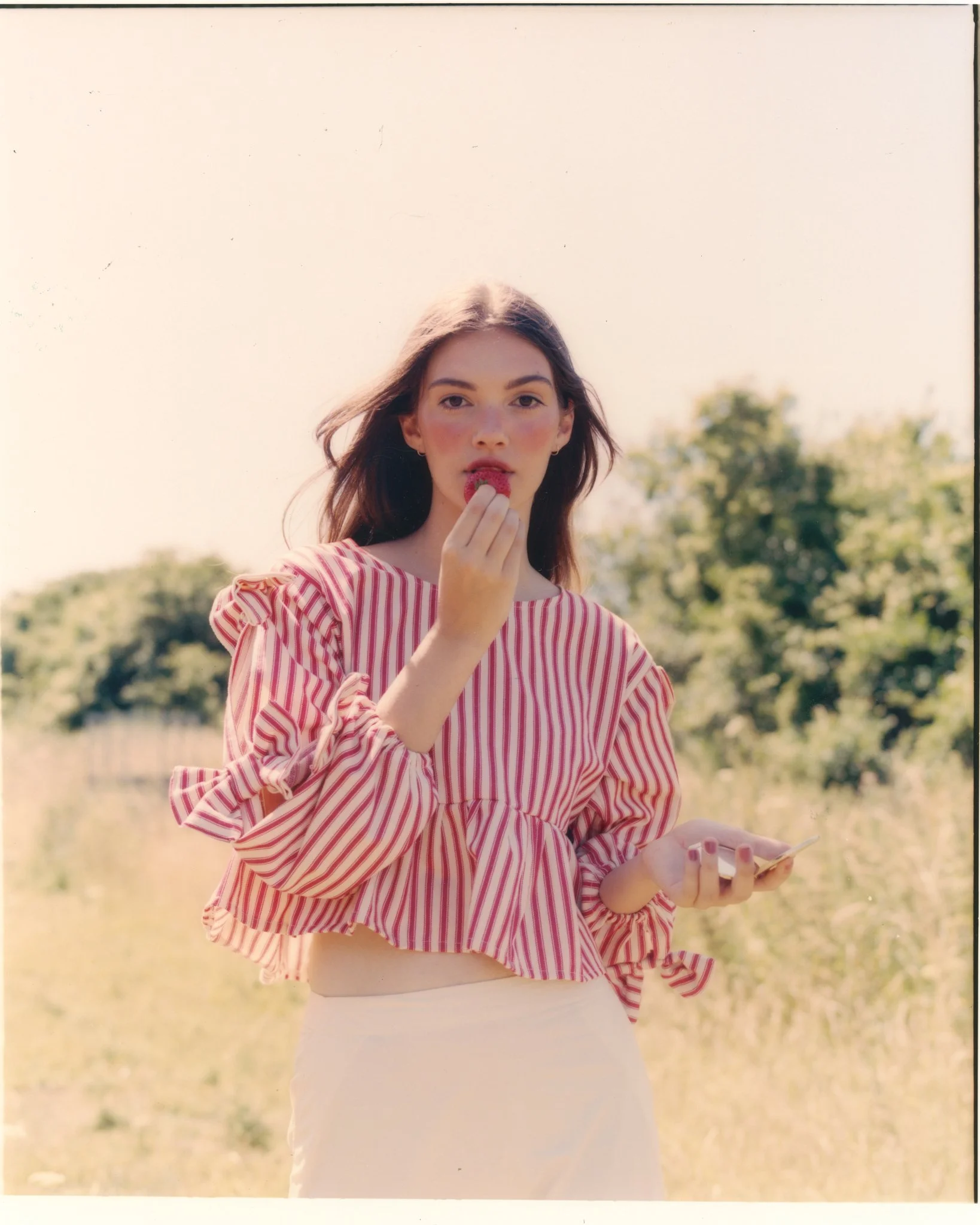 Outdoor fashion portrait. Natural‑light editorial makeup with fresh skin and soft definition. Created by Kinga for fashion editorial "Strawberry farm" shoot.