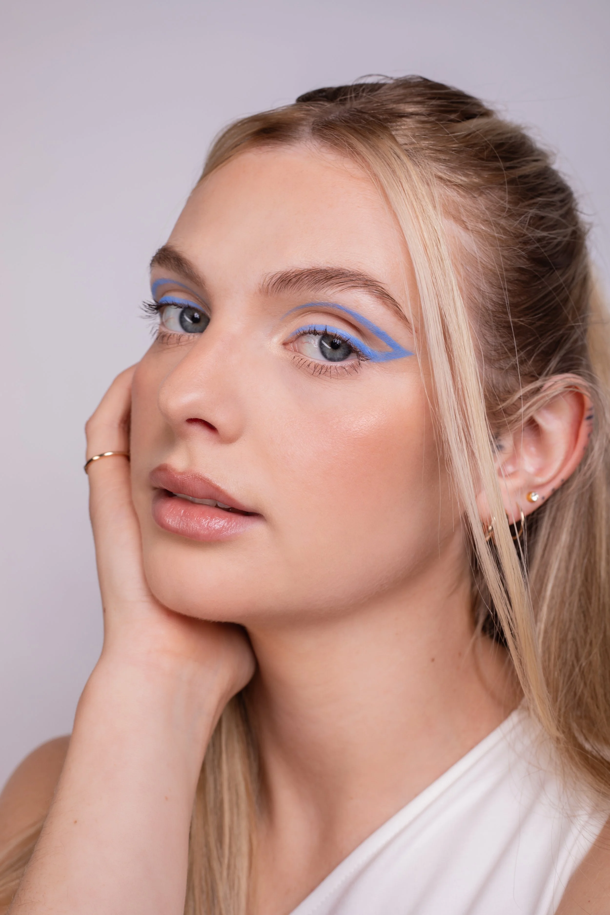 Pippa of London beauty Campaign. Beauty makeup by Kinga featuring bold blue shimmer, clean skin, and refined detailing. Perfect for beauty campaigns and modern commercial work.