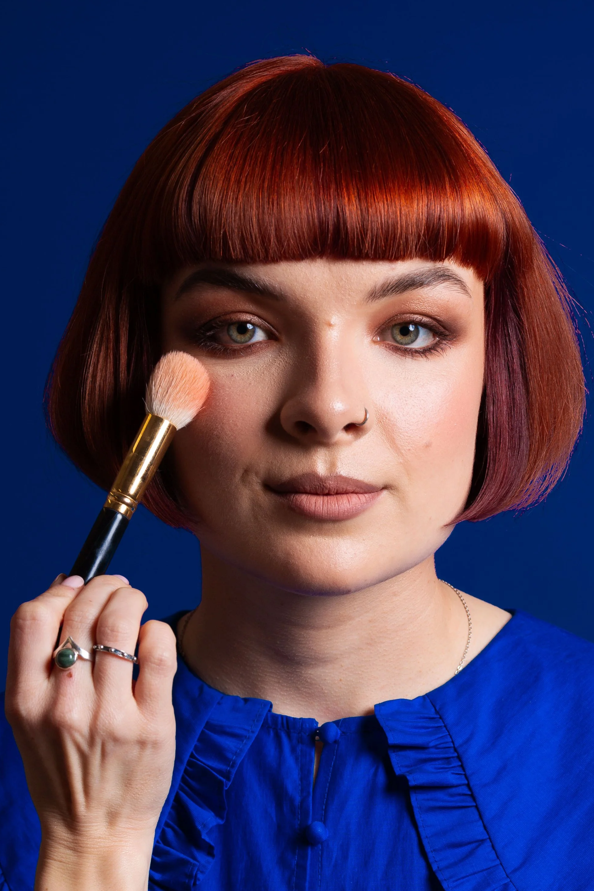 Makeup artist applying blush during an editorial photoshoot in Leeds