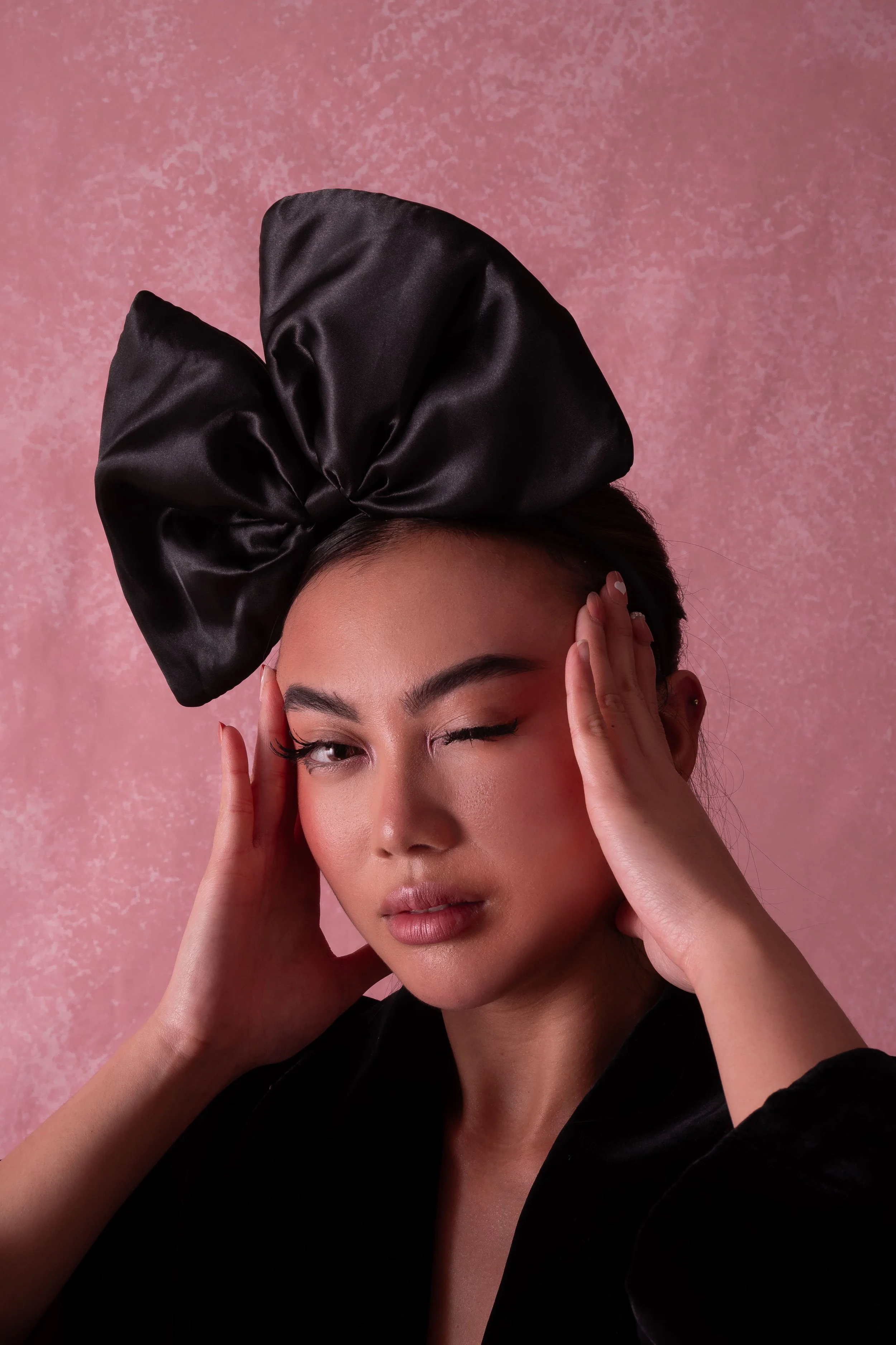 Pink‑tone close‑up portrait. Radiant, skin‑focused makeup with soft blush tones and delicate detailing. Editorial beauty by Kinga, celebrating inclusive, expressive artistry.