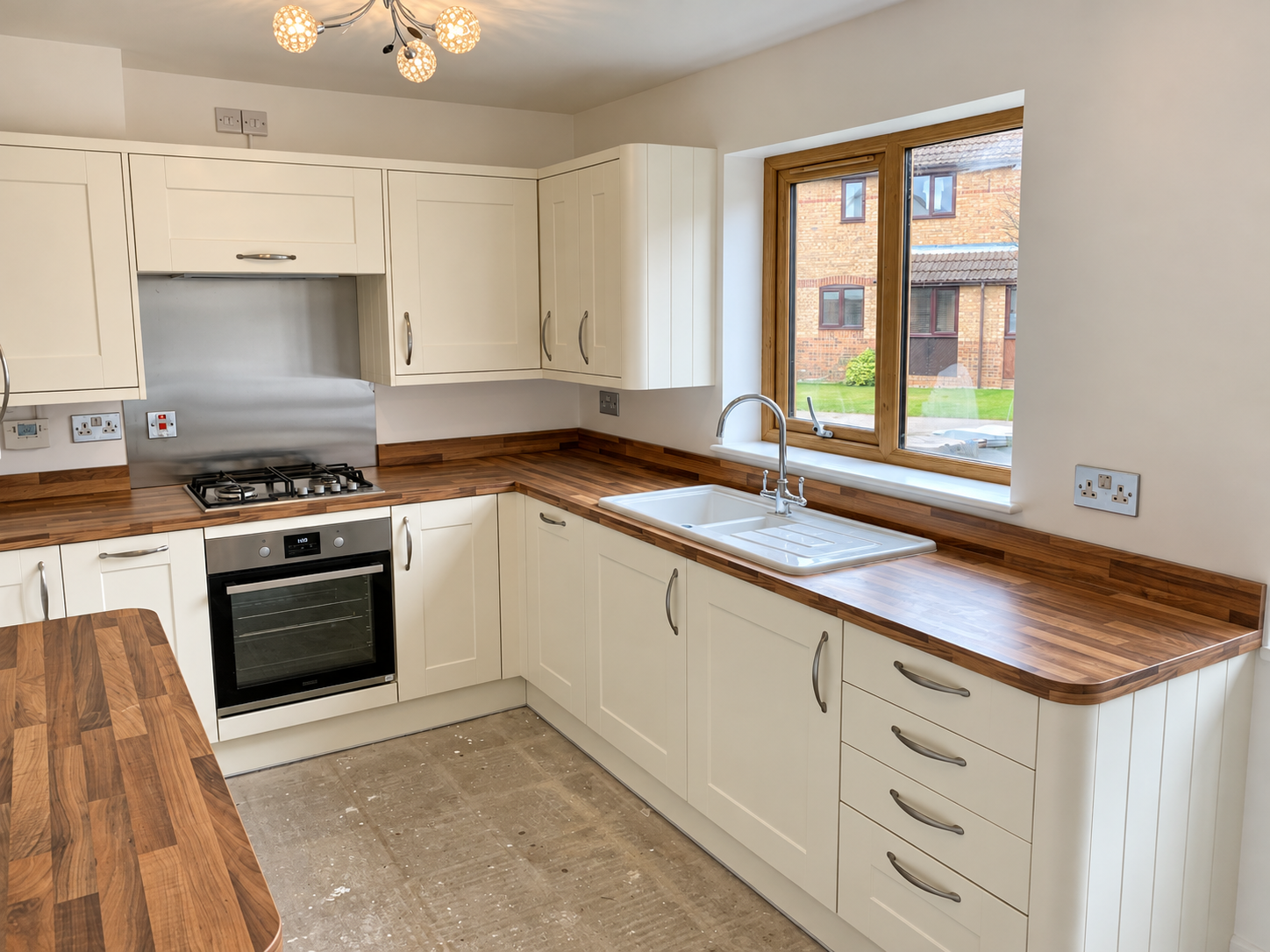 Renovated Cream Kitchen with Unfinished Flooring.png