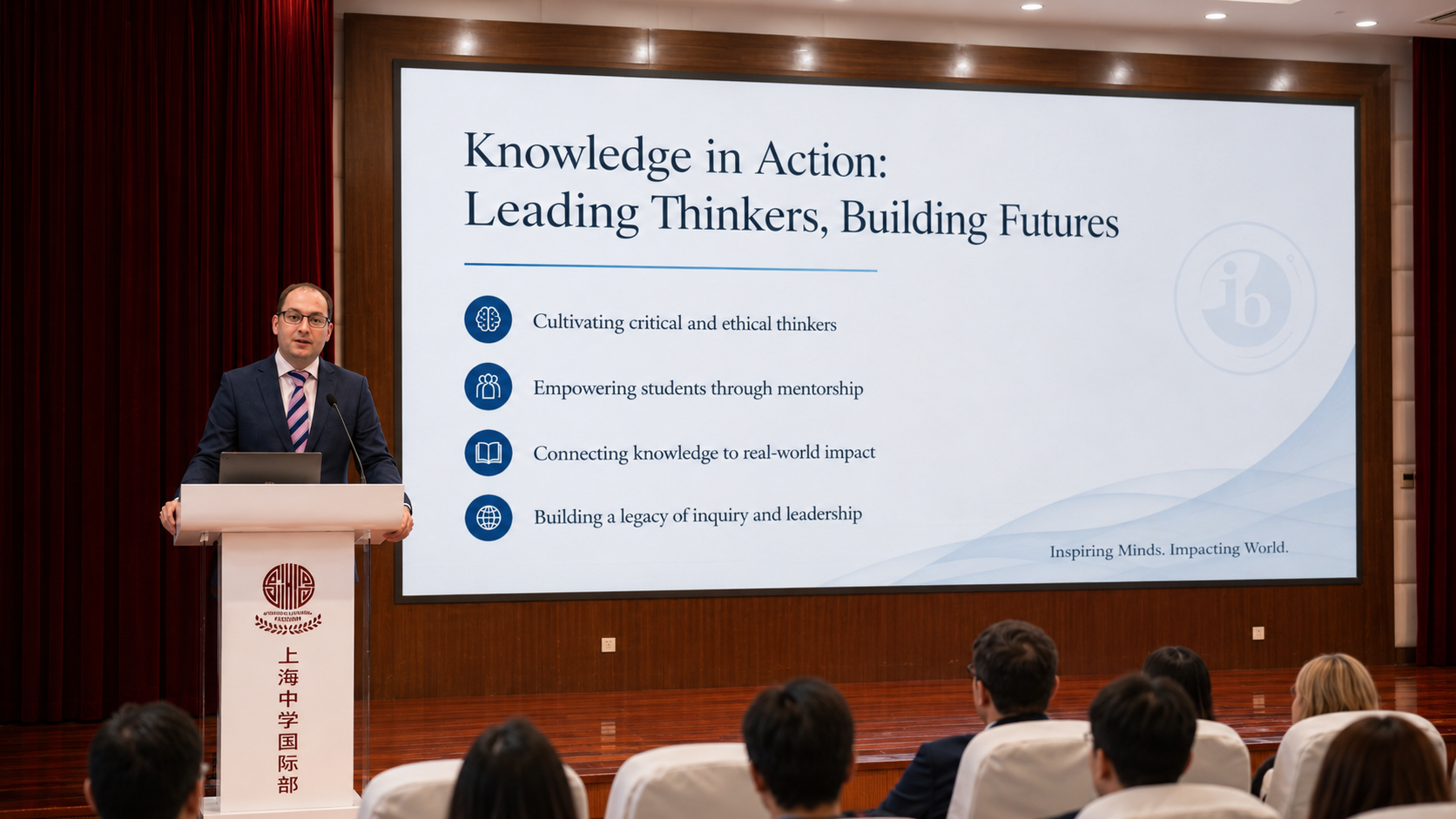 Joshua Pickart is at a podium delivering a presentation to an audience. The presentation slide is about cultivating critical thinkers, mentoring students, connecting knowledge to real-world impact, and building a legacy of inquiry and leadership.