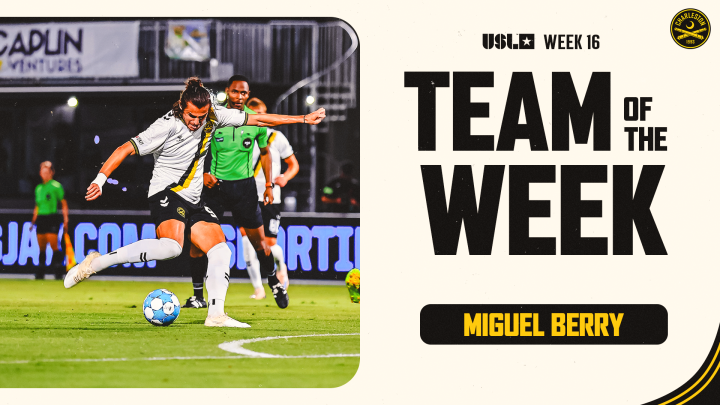 Soccer player in a white jersey and black shorts kicking a soccer ball during a match, with a female referee in a green uniform and other players in the background; graphic design on the right side with bold text reading 'Week 16 Team of the Week' and 'Miguel Berry'.