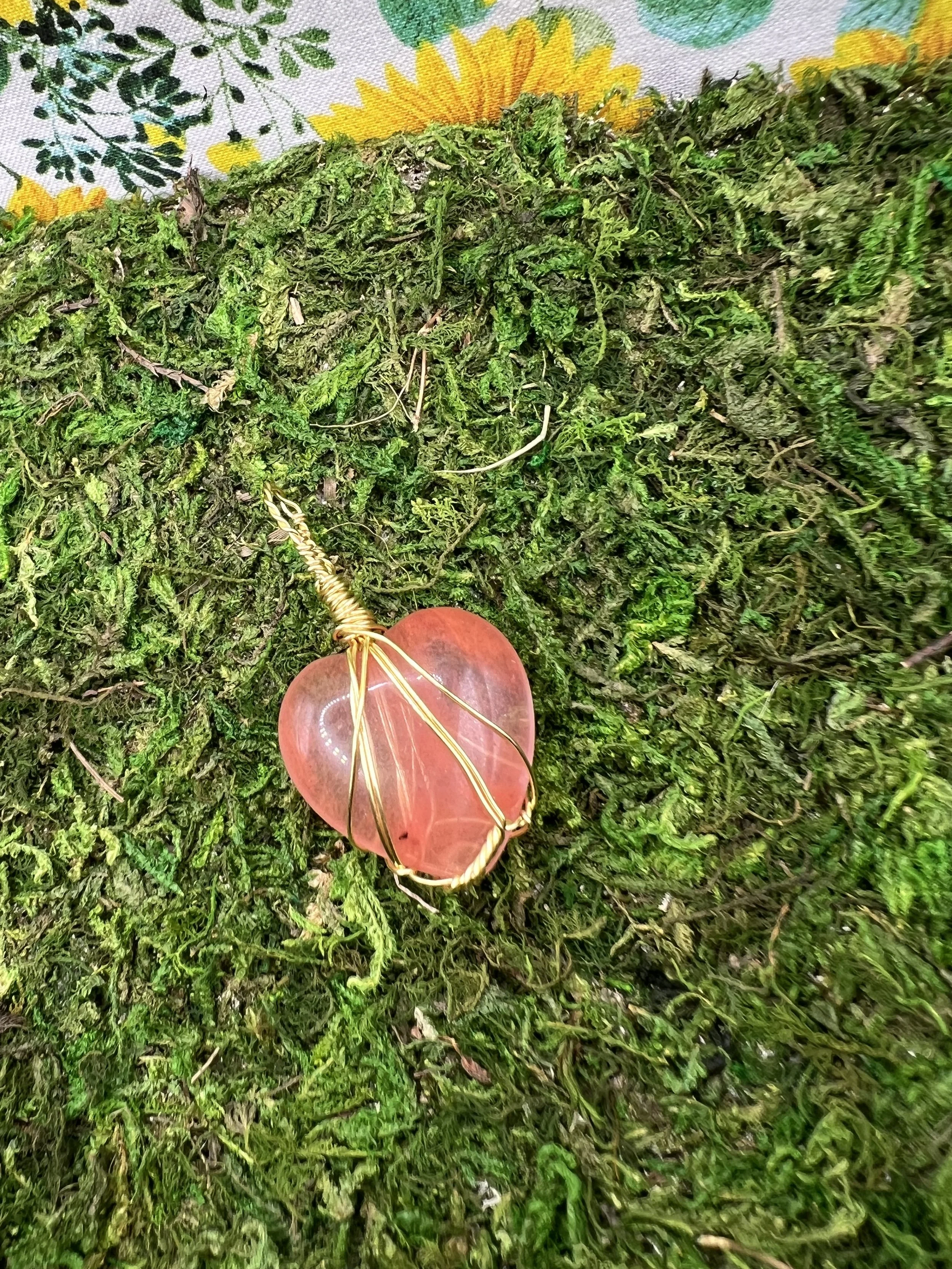 Close-up of a reddish-brown flower resting on green moss.