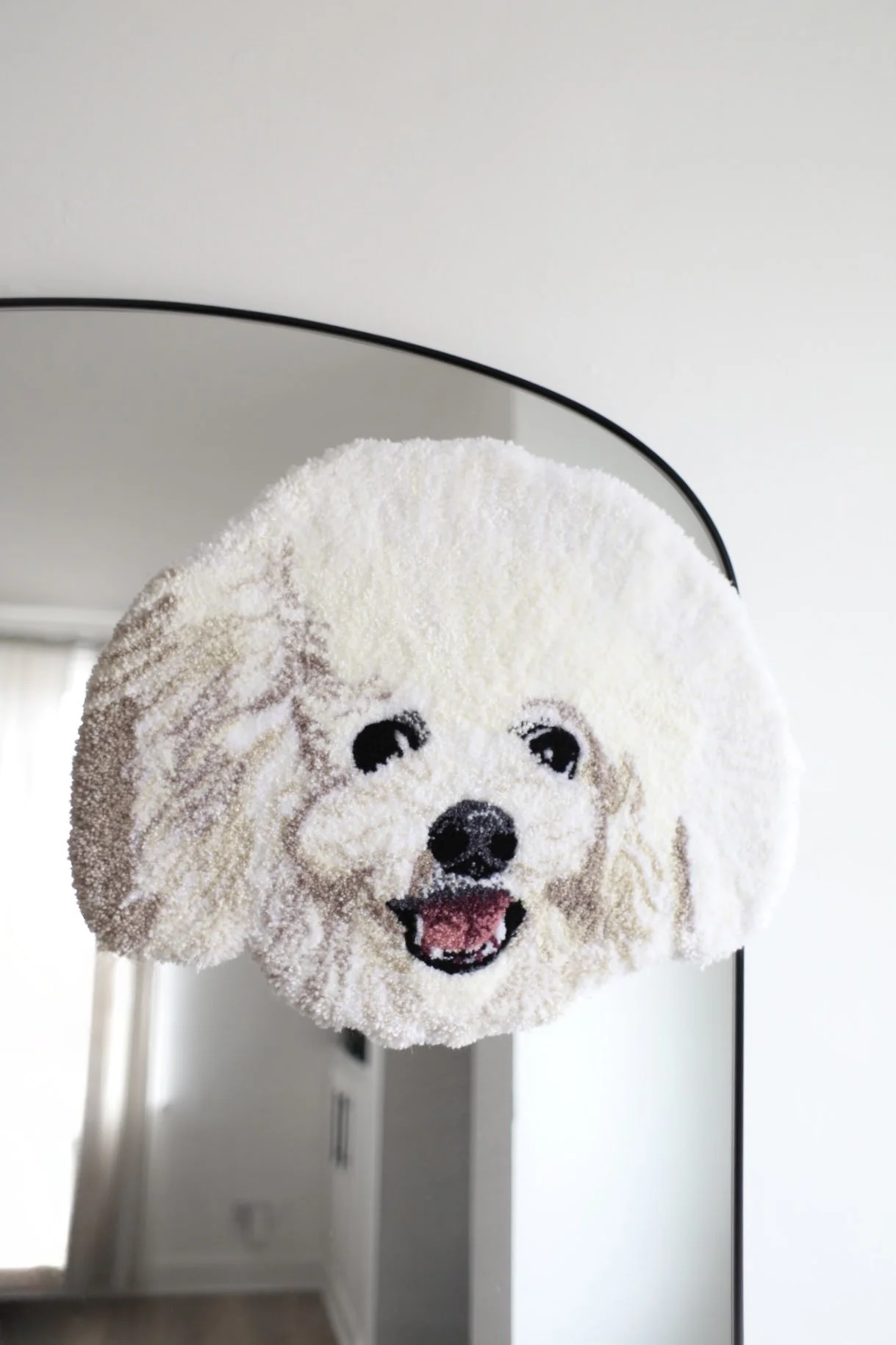 Realistic white dog portrait rug placed on a mirror.