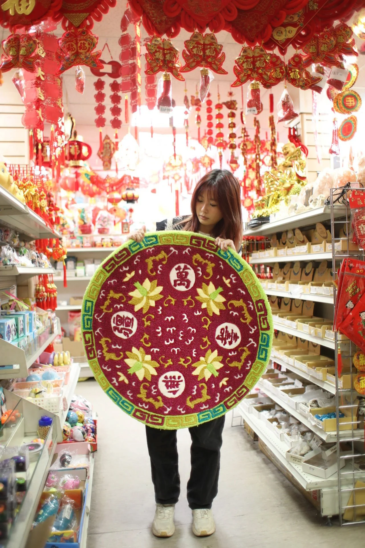 Maker holding her handmade Boundless Longevity rug