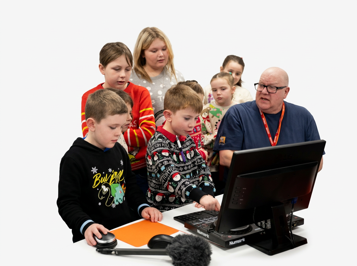 A group of children and an adult gathered around a computer and DJ equipment, with a white background.