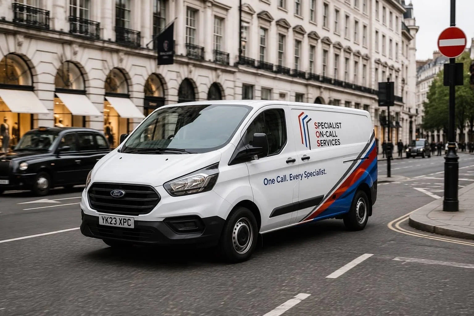 White delivery van on city street with advertising saying 'Specialist On-Call Services' and 'One Call. Every Specialist.'