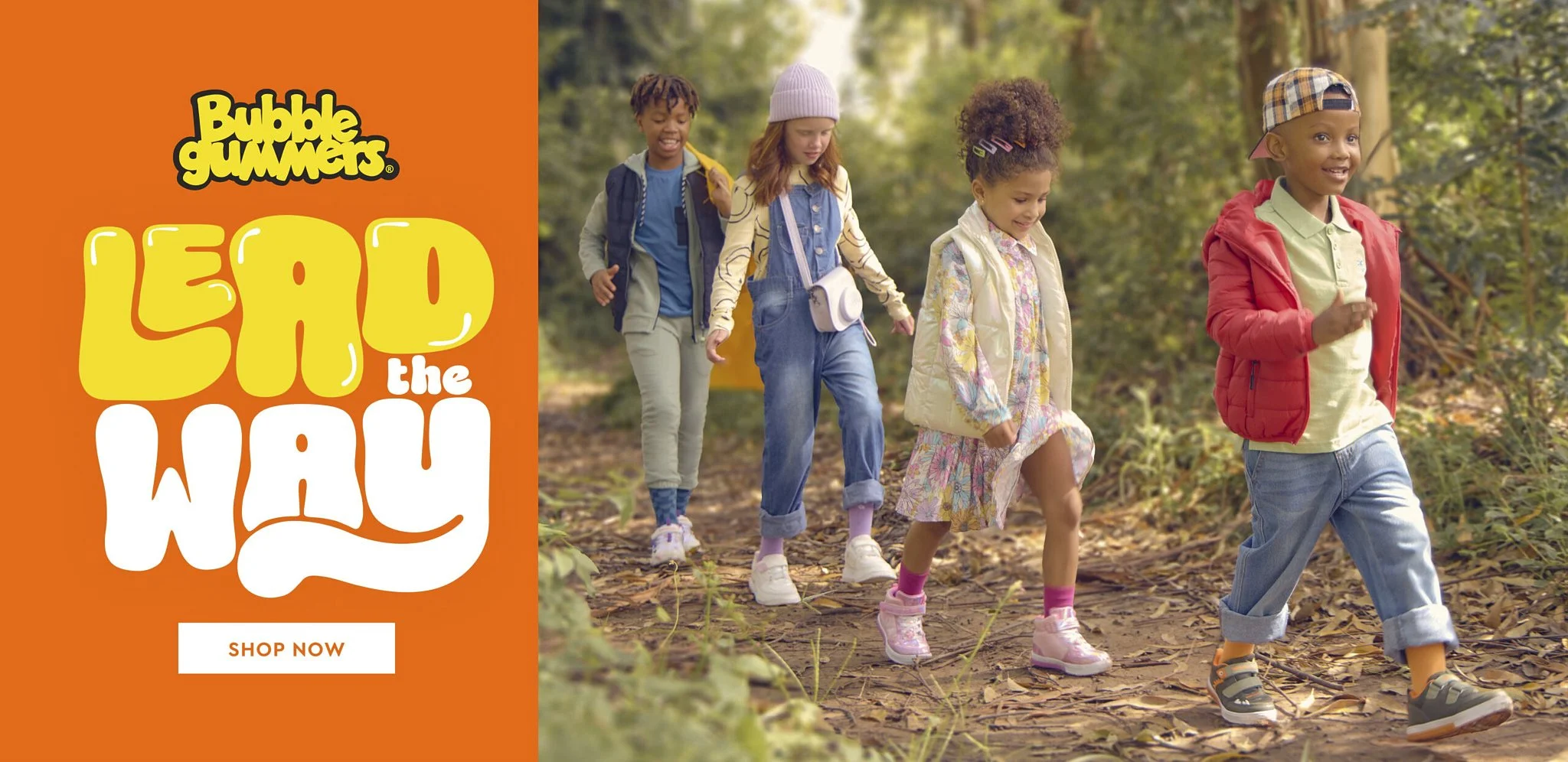 A group of five children walking on a forest trail during fall, dressed in colorful jackets, hats, and casual clothing, smiling and enjoying outdoor activity. Advertising Bubblgummers shoes