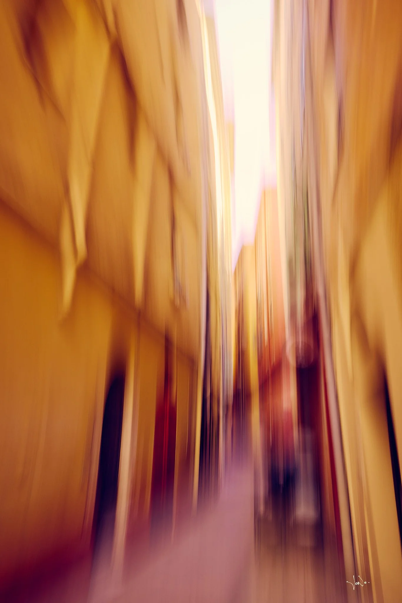 The photo appears to be blurry, showing vertical streaks of yellow, brown, and purple colors, with no clear objects or scene identifiable. An ICM photo shot in Old Town Nice, France.