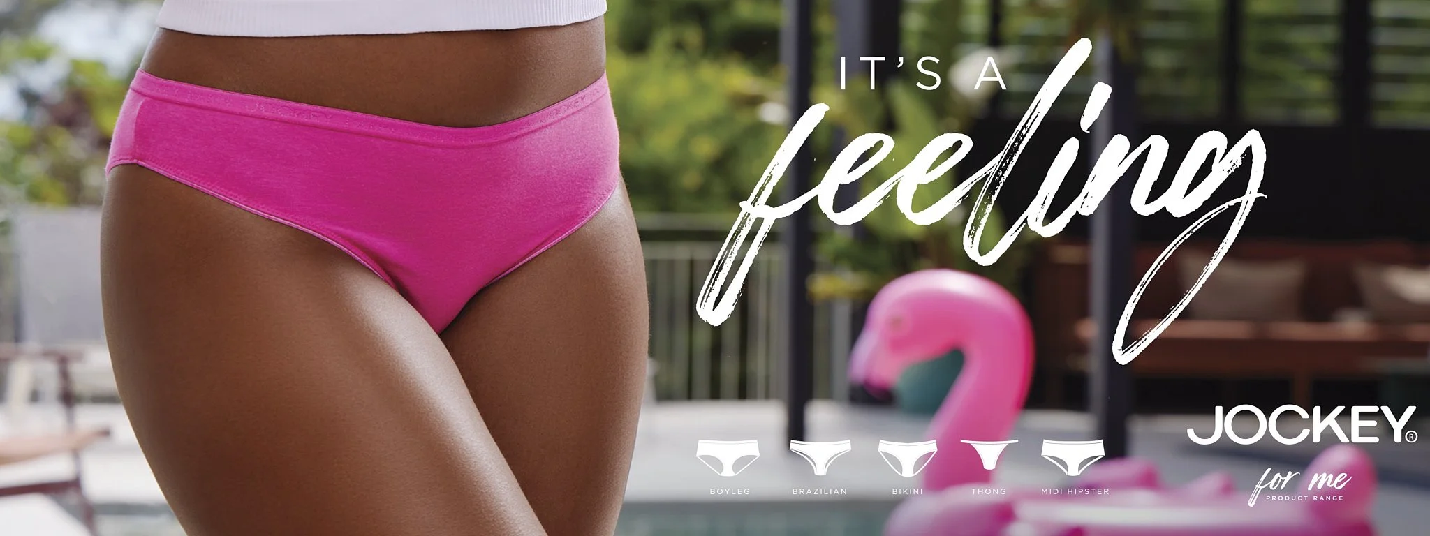 Close-up of a woman's hips wearing bright pink bikini bottoms, with a blurred outdoor background and a pink flamingo pool float visible. Jockey underwear advert