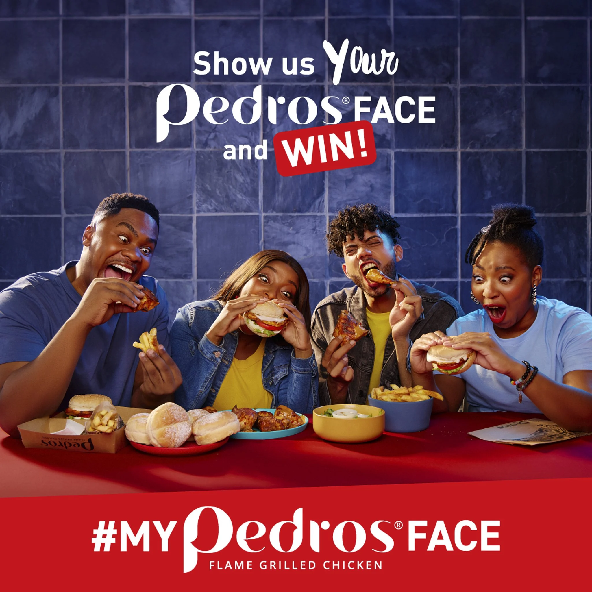 Young people enjoying fried chicken sandwiches and French fries at a table with a spread of food, at a promotional event for Pedros' flame grilled chicken, with a sign displaying 'Show us your Pedros' face and win!'