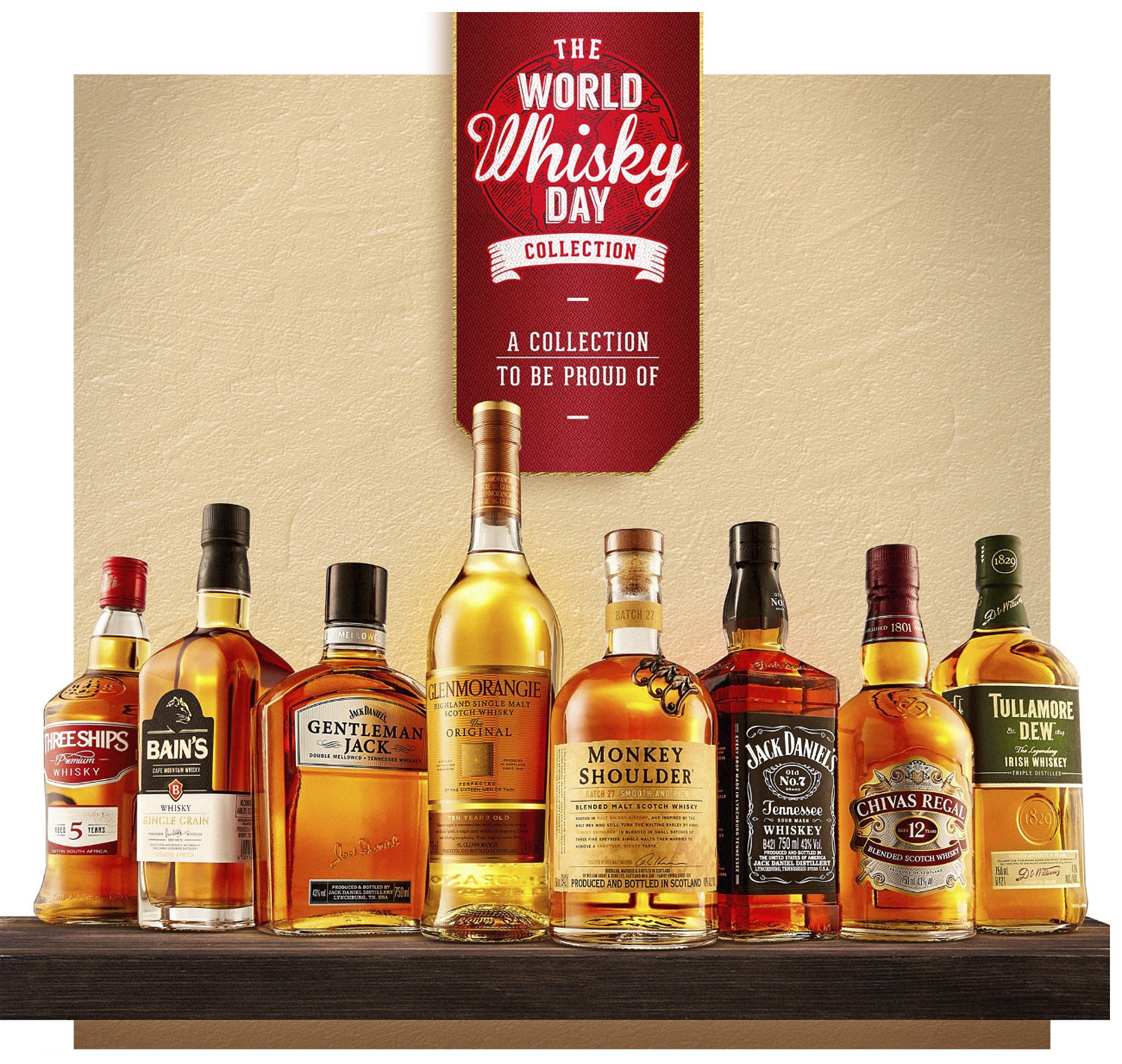 Collection of various whiskey bottles arranged on a shelf with a banner overhead that reads "The World Whisky Day Collection."