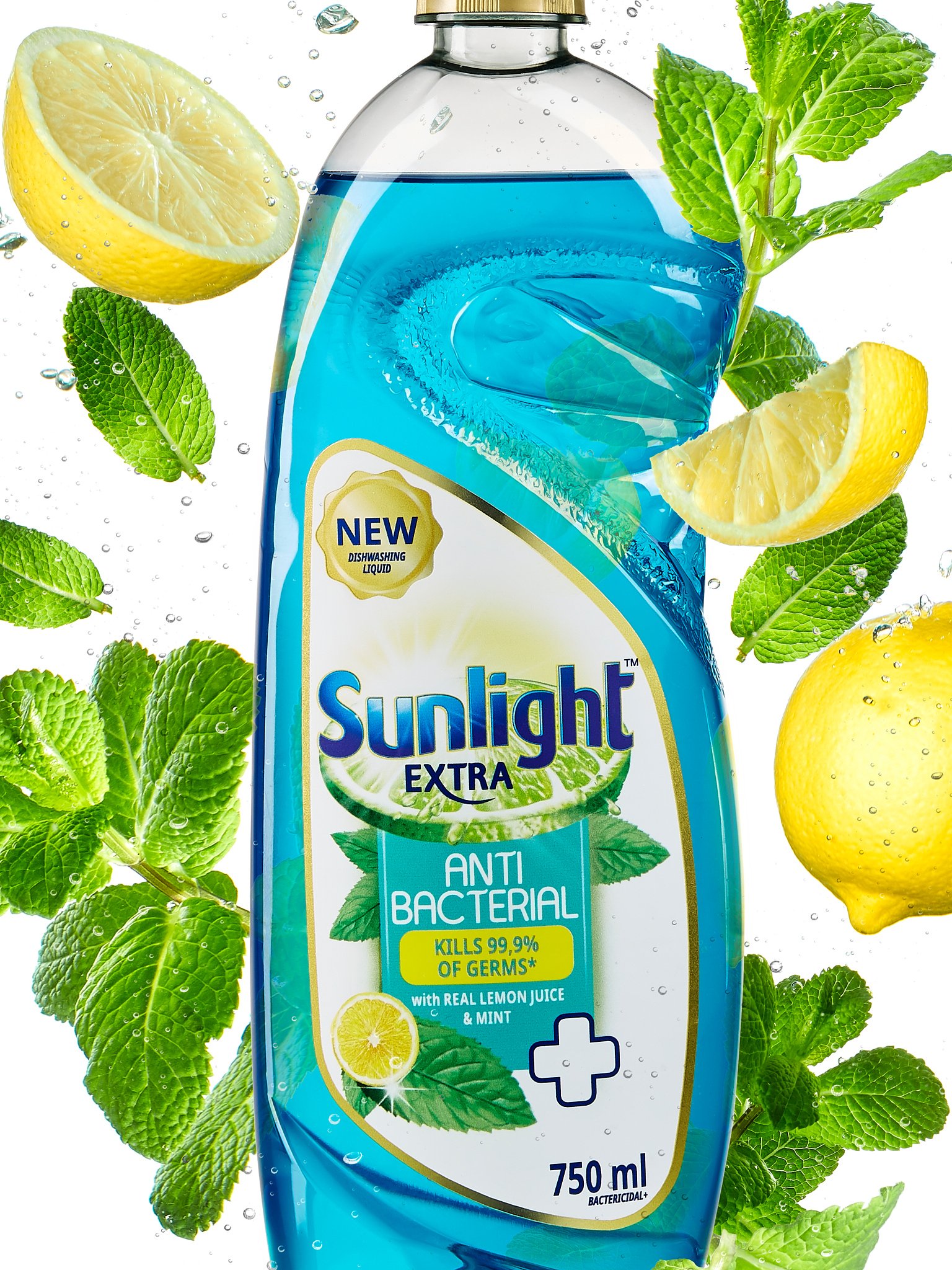 A 750ml bottle of Sunlight Extra antibacterial dishwashing liquid with real lemon juice and mint, surrounded by lemon wedges and fresh mint leaves, suspended in water.