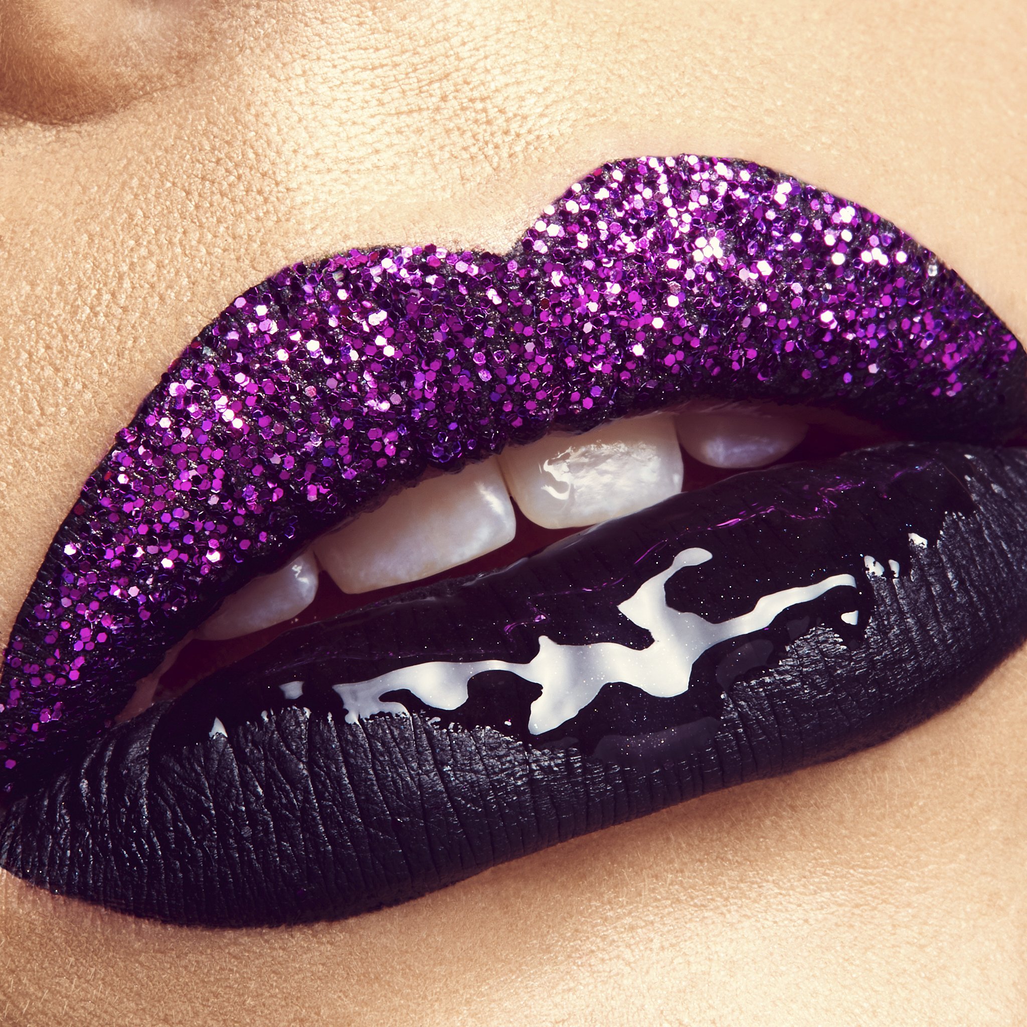 Close-up of a person's lips covered in purple glitter lipstick, with a black lace detail below.