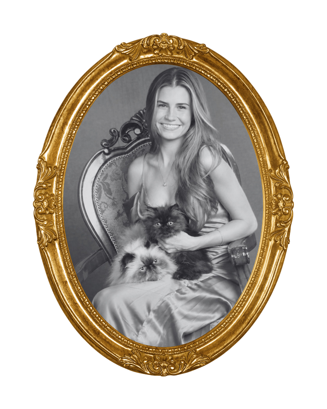 Black and white portrait of a smiling woman with long hair, sitting on a vintage chair, holding two cats, one black and one light-colored, in front of a plain background, within a gold ornate oval frame.