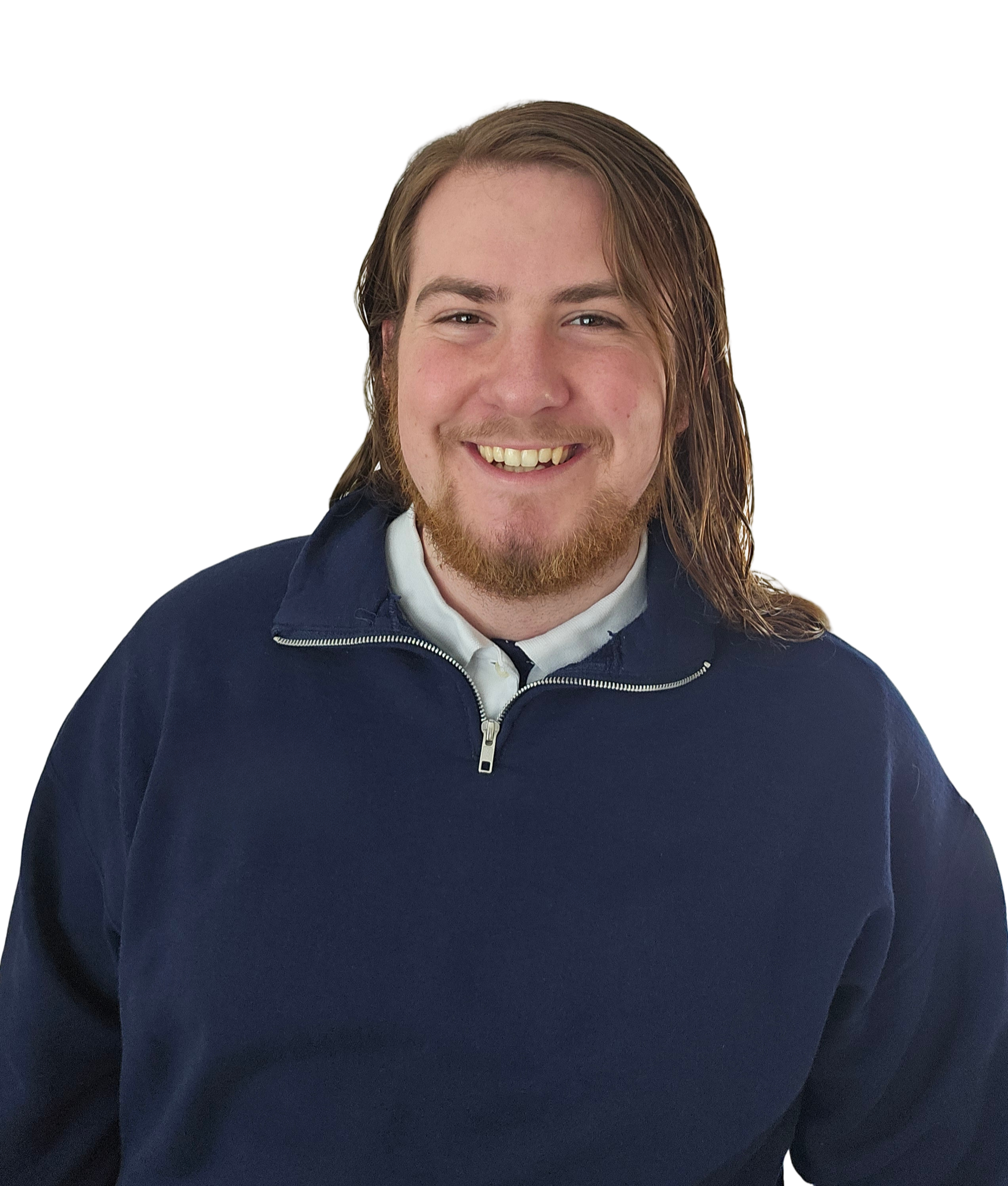 Close-up of a smiling young man with long, light brown hair, facial hair, wearing a navy blue zip-up jacket over a white collared shirt.