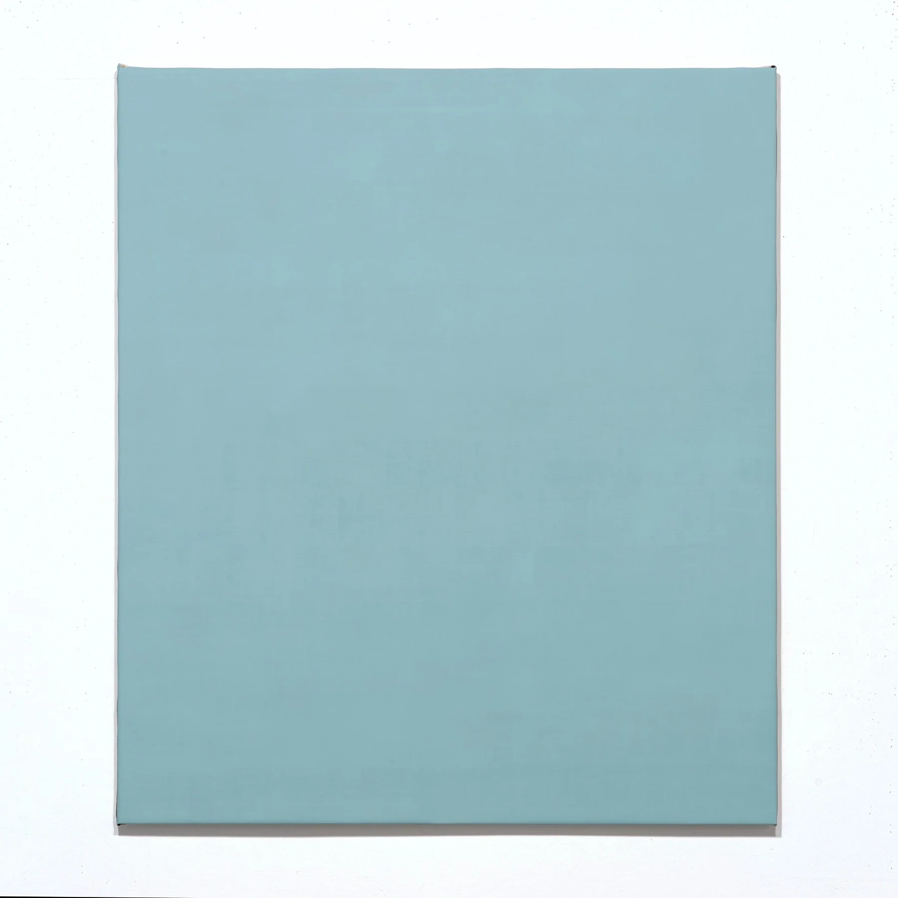 A flat, square, light blue hardware case or box with a smooth surface, set against a white background.