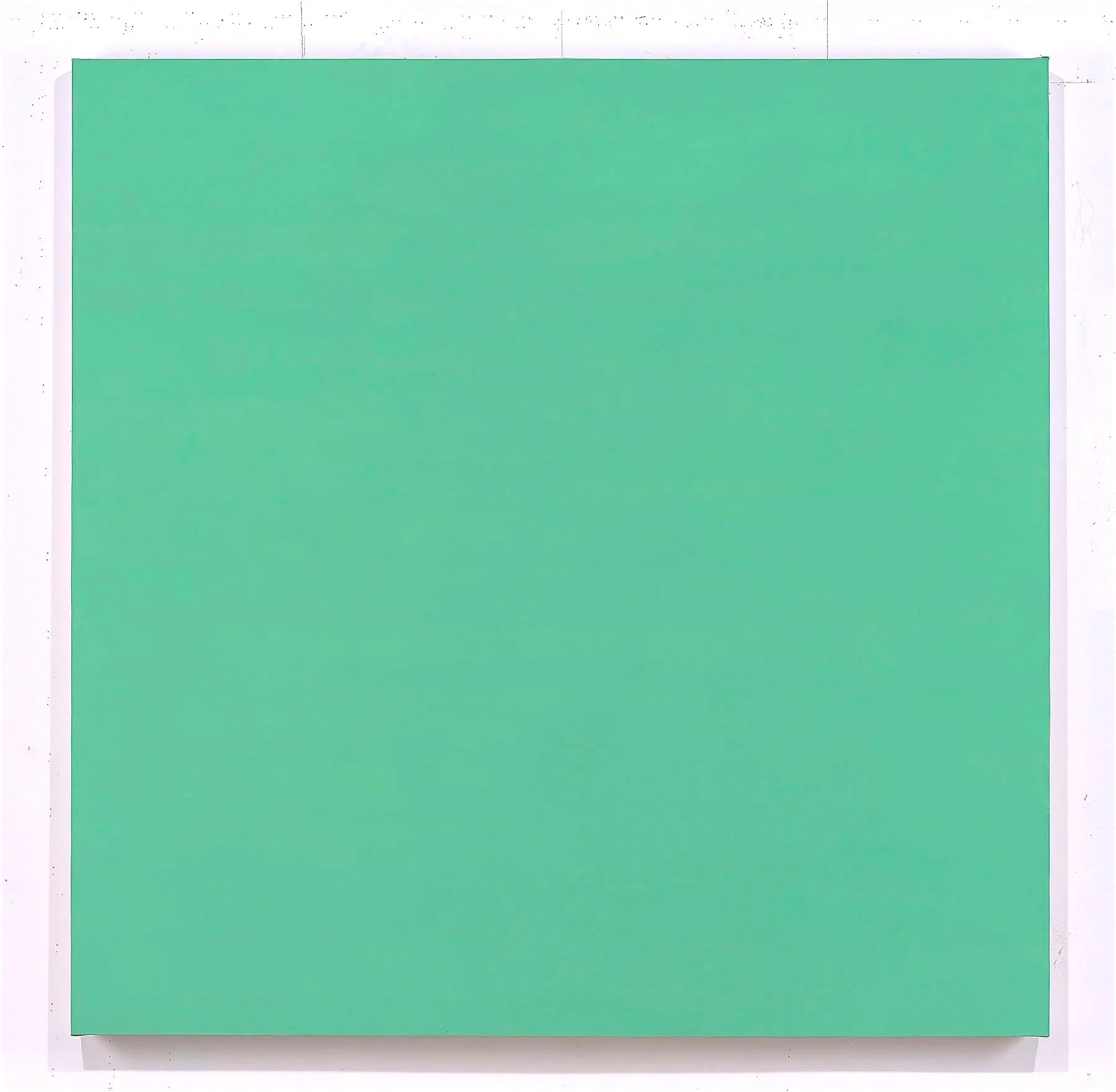 A light green rectangular cardboard box placed on a white surface.