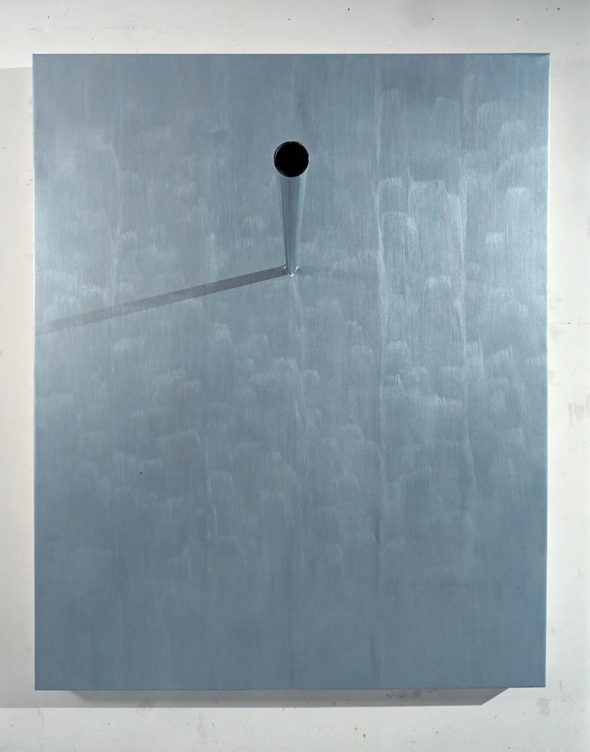 A blue rectangular canvas with a round hole near the top center and a cone-shaped shadow cast to the lower left.