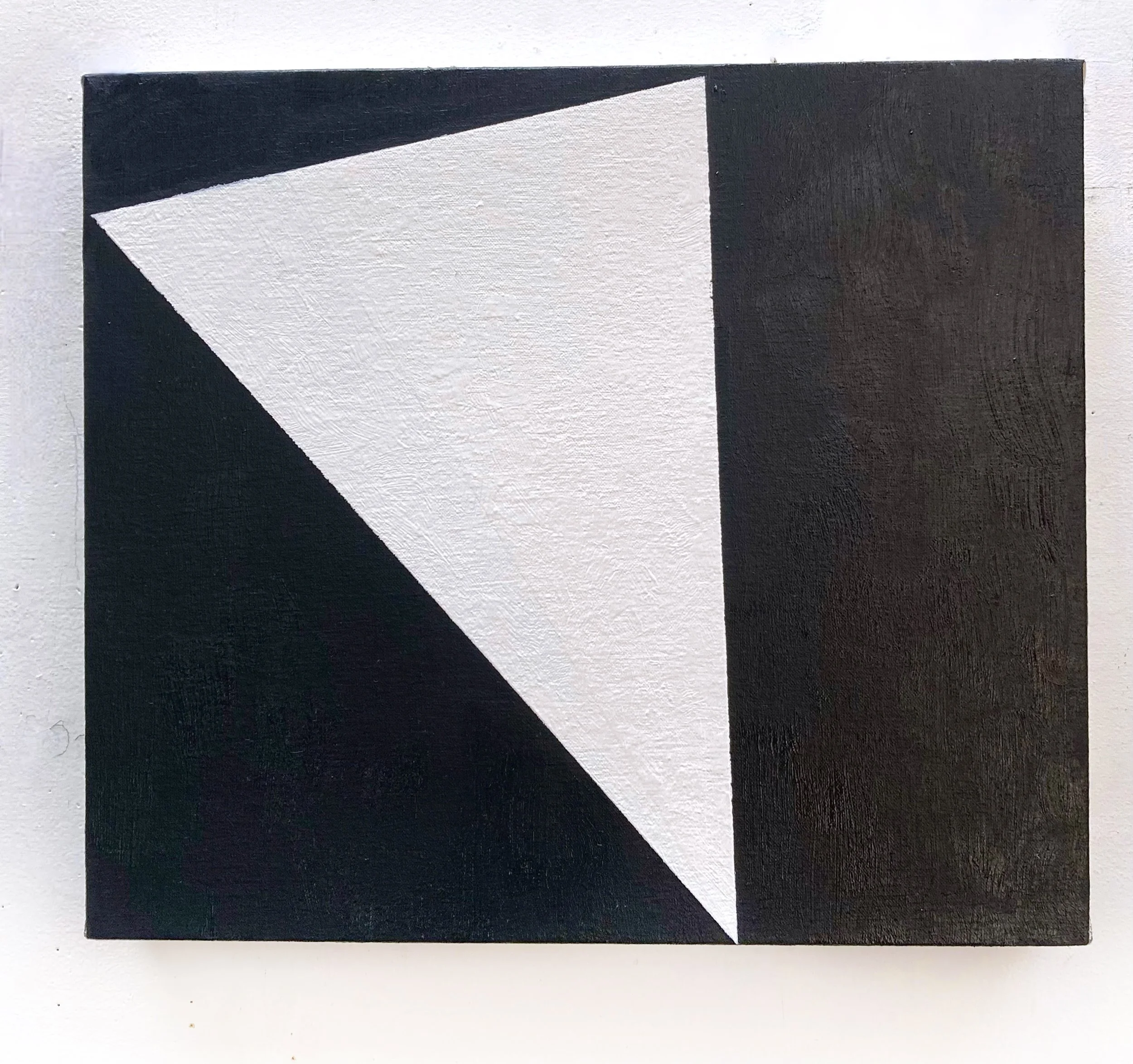 A black and white geometric abstract painting with bold shapes and sharp angles.