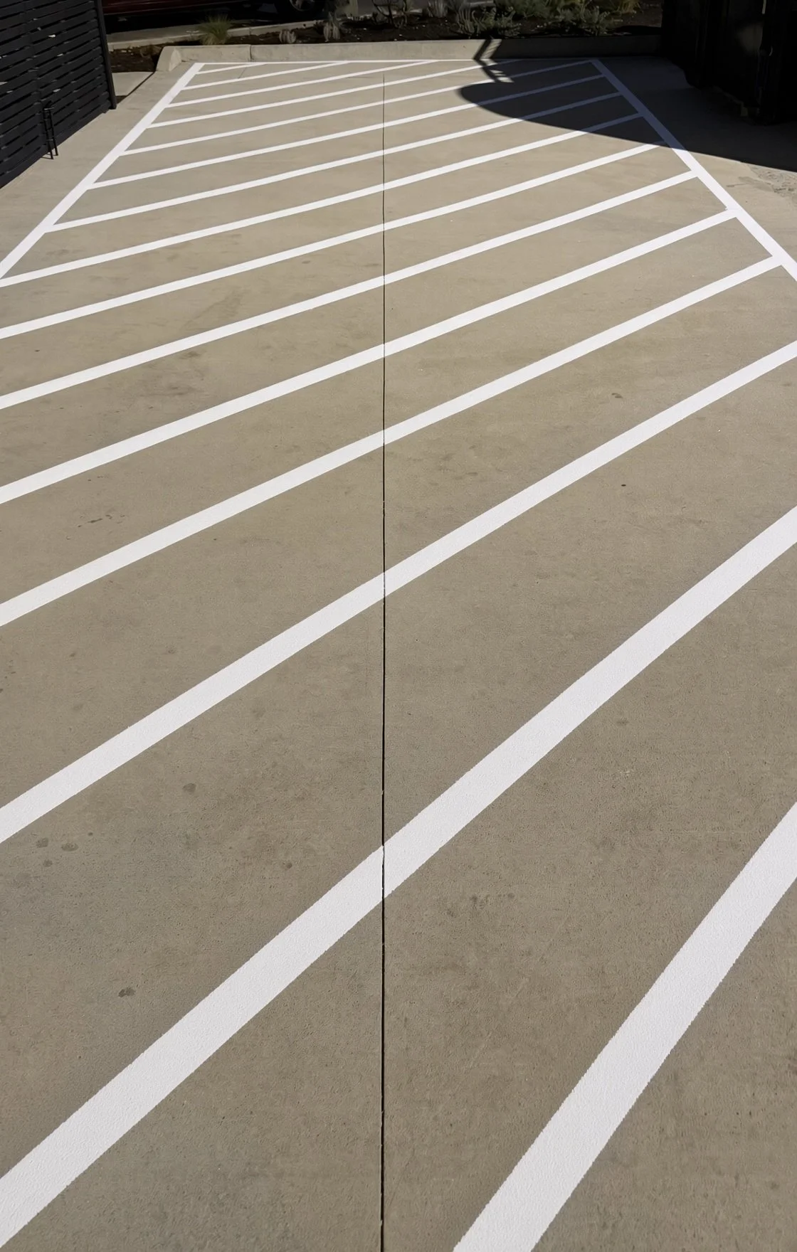 White hash mark striping on a parking lot in Northwest Arkansas