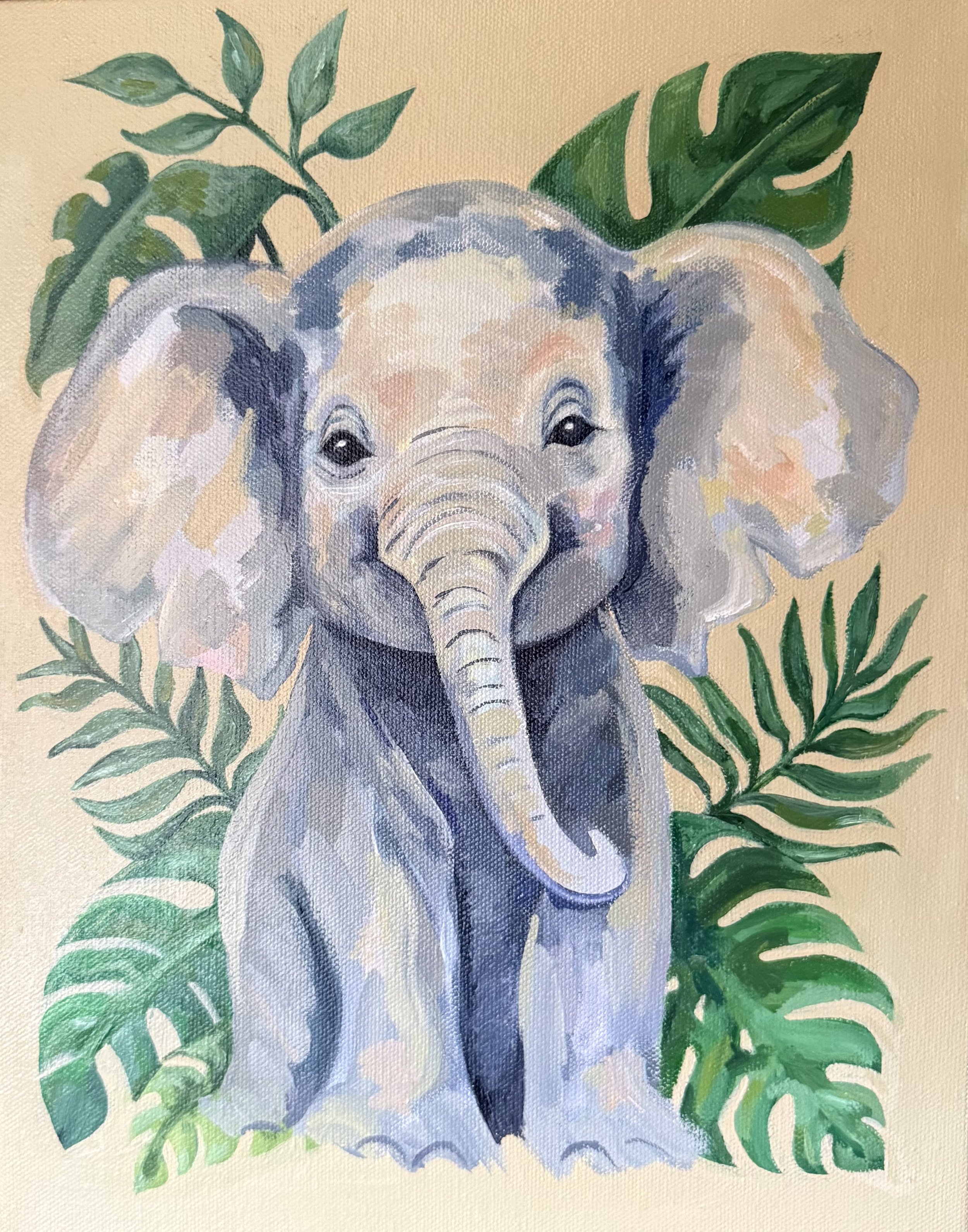 Watercolor painting of a baby elephant surrounded by green leaves.