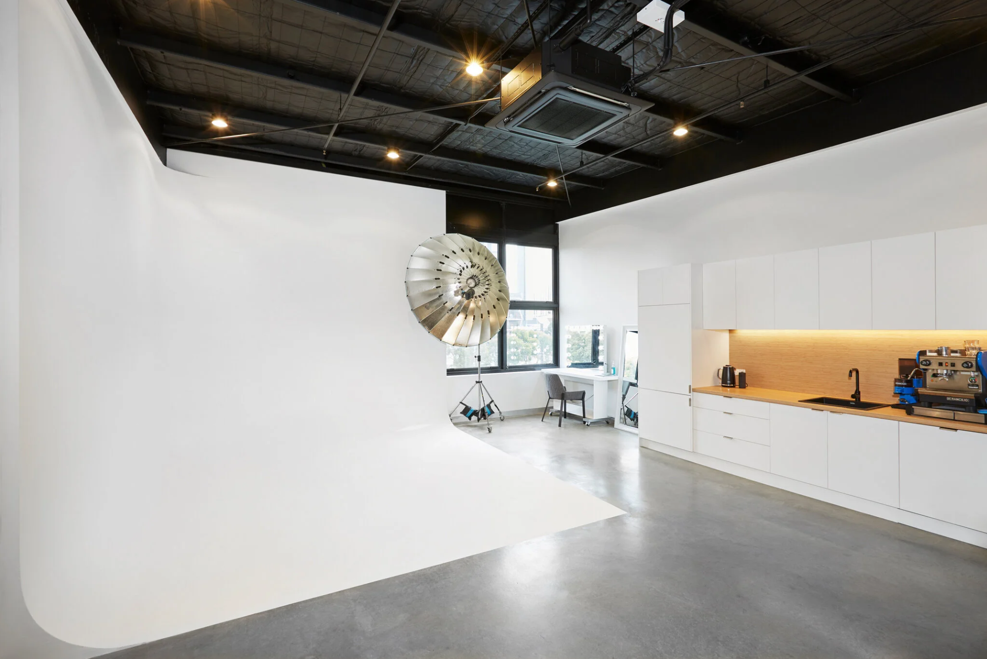 Curved white cyclorama wall with studio lighting setup