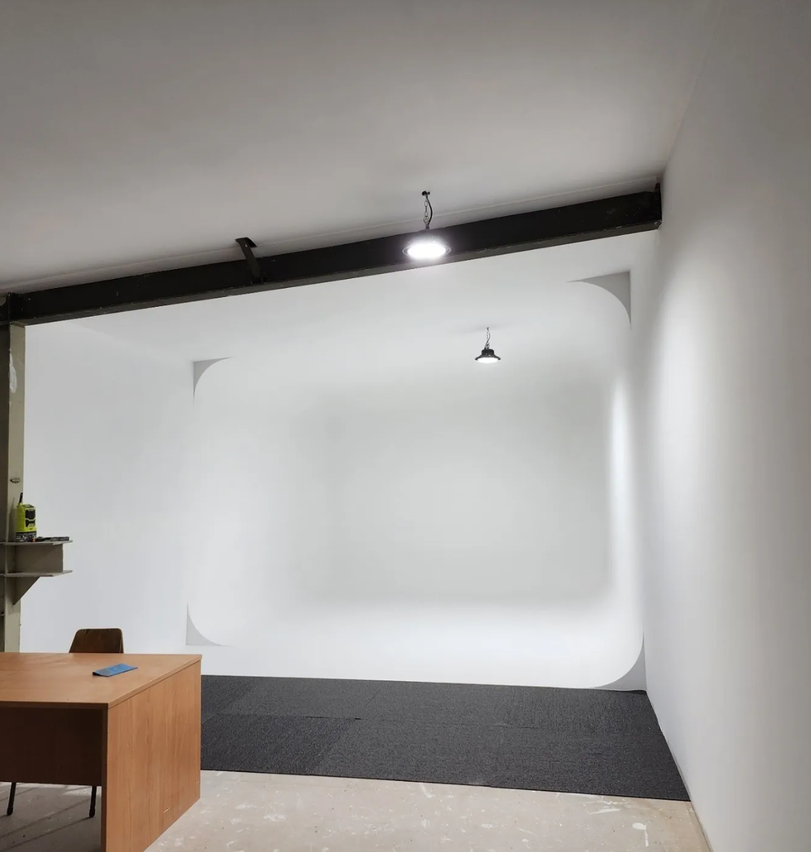 Compact home studio with white cyclorama wall installation — Covingsmith