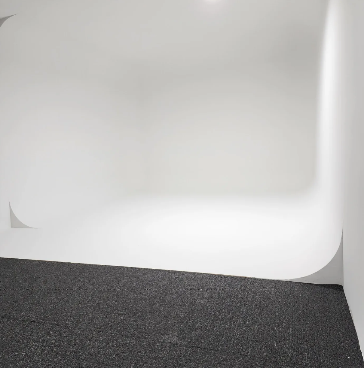 Finished white cyclorama wall with curved corners in photo studio