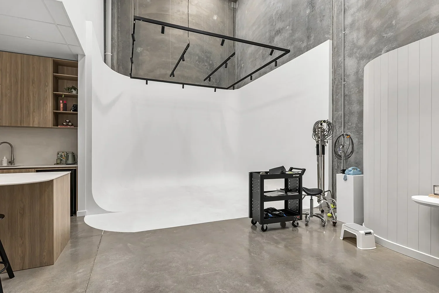 Cyclorama wall installation with overhead lighting rig in industrial studio space