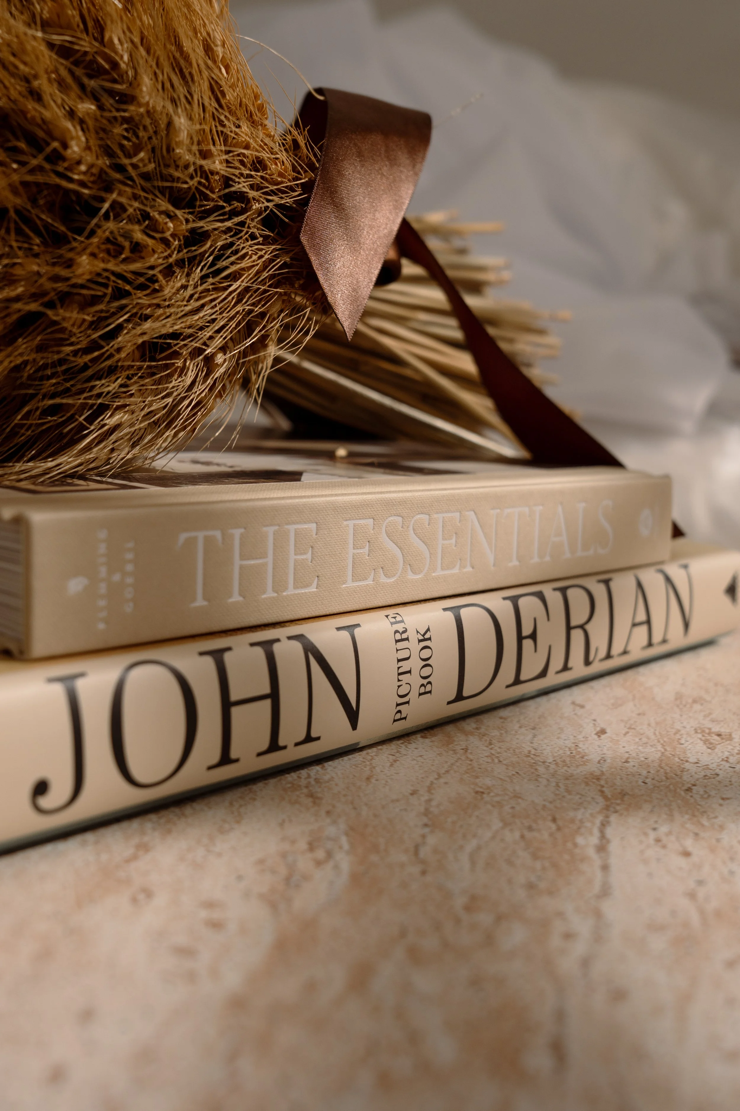 Image of books on top of a travertine coffee table.