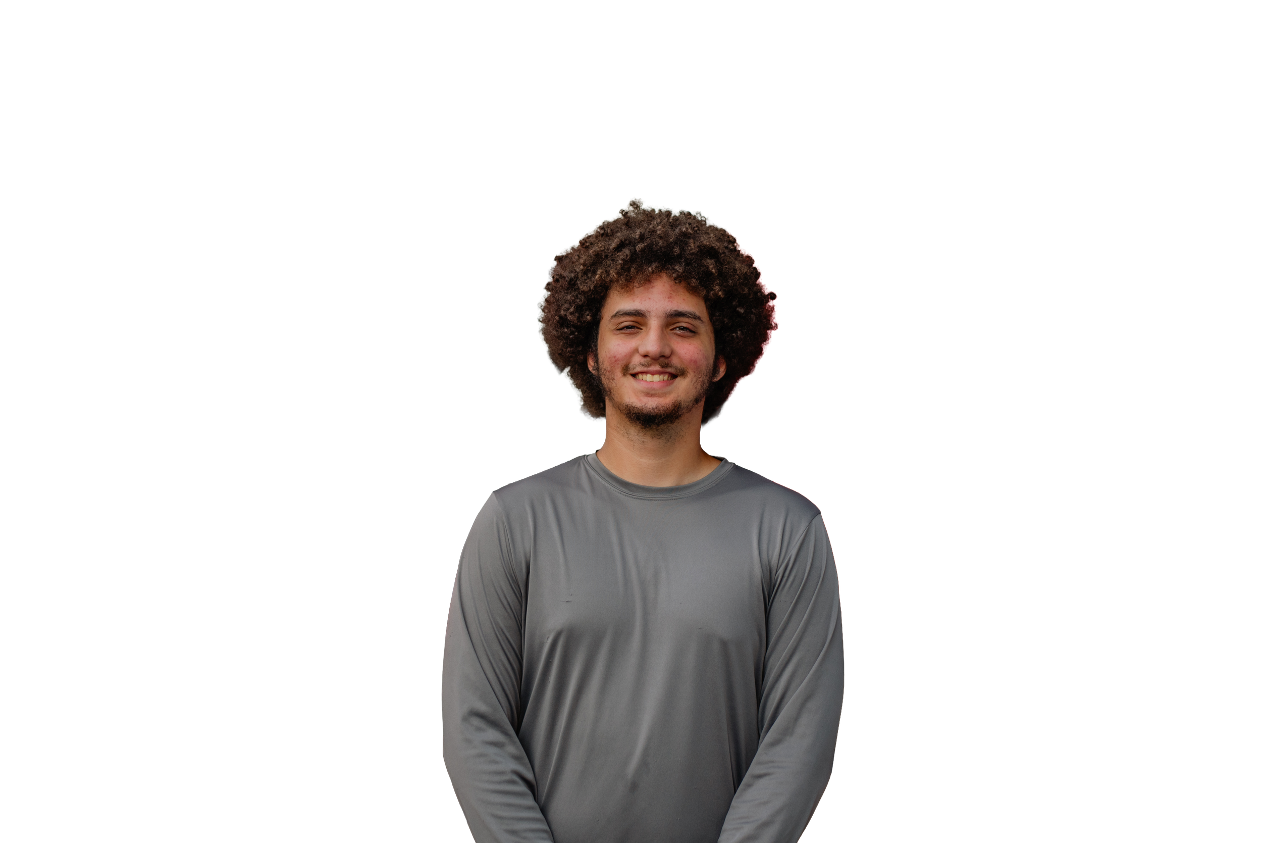Young man with curly hair smiling, wearing a gray shirt, standing in front of colorful horizontal lines.