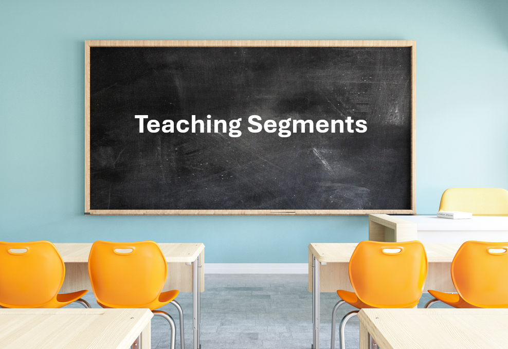 Classroom with a blackboard that says "Teaching Segments" and empty orange and yellow chairs.