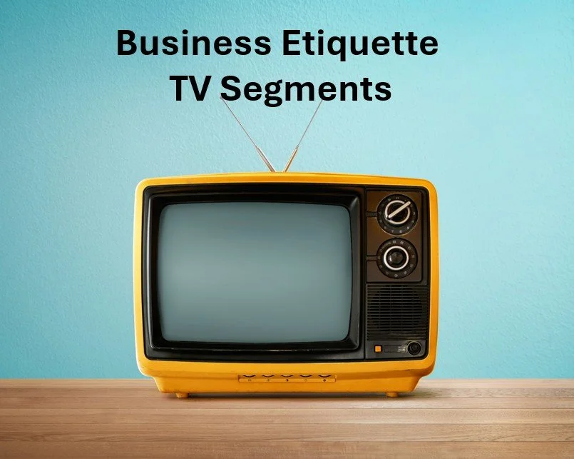 A vintage yellow television set on a wooden surface with a light blue wall in the background. Text on the wall reads "Business Etiquette TV Segments."