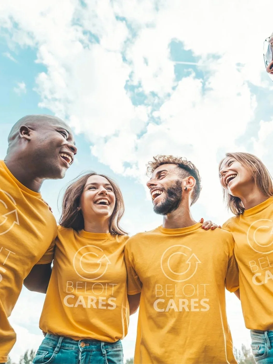 Group of five diverse people wearing yellow t-shirts with