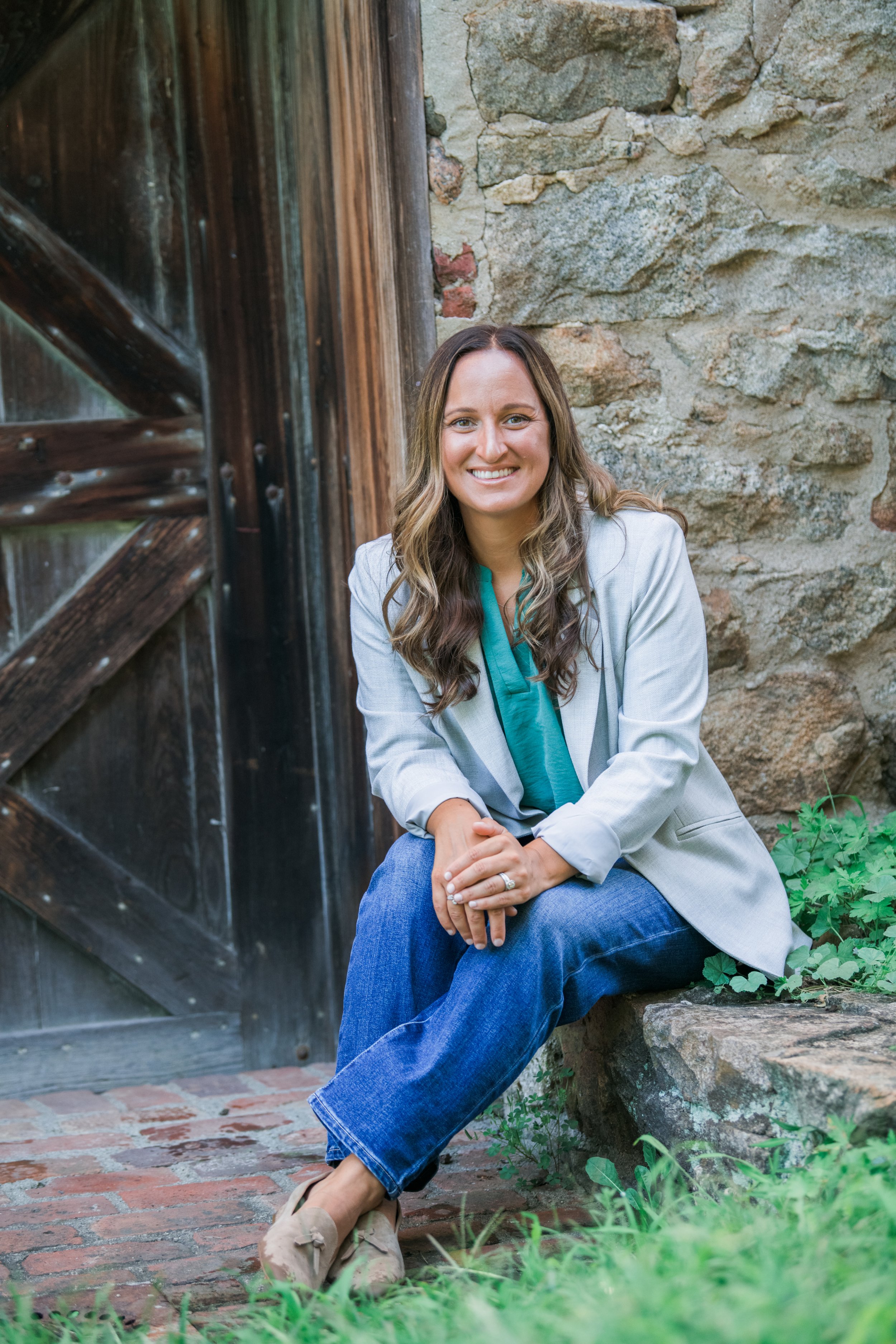 Melissa Parrish, LPC, therapist in Hackettstown NJ, smiling outdoors near a wooden door