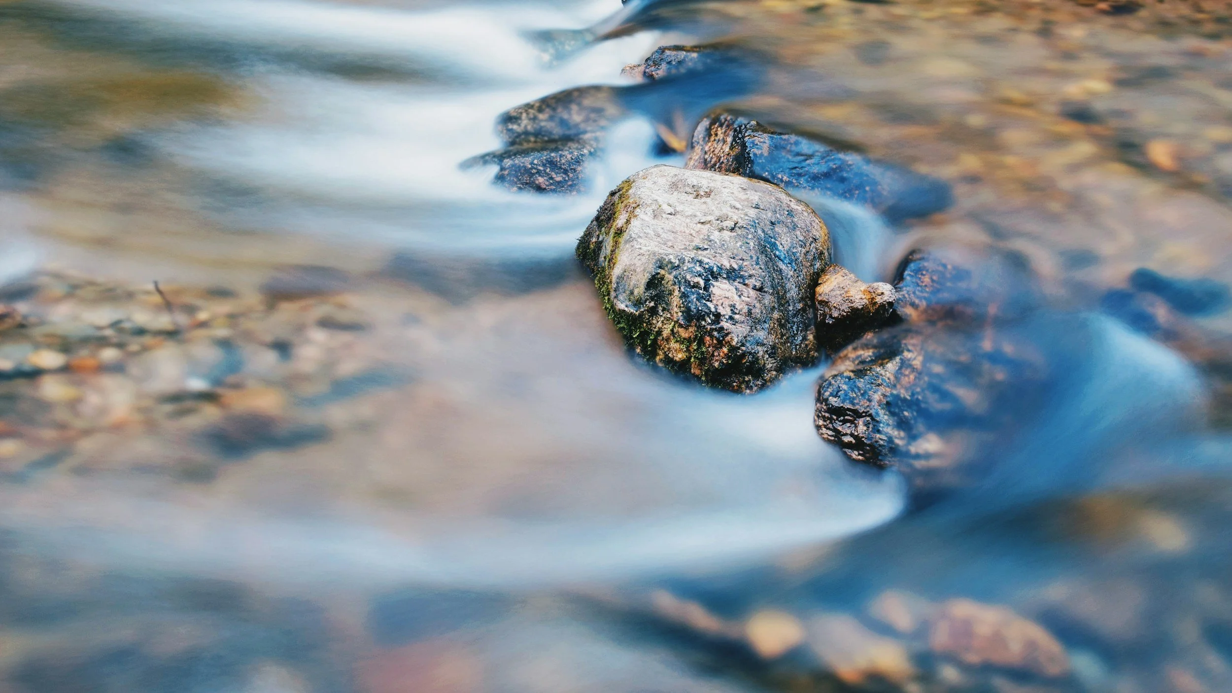 River rocks surrounded by moving water