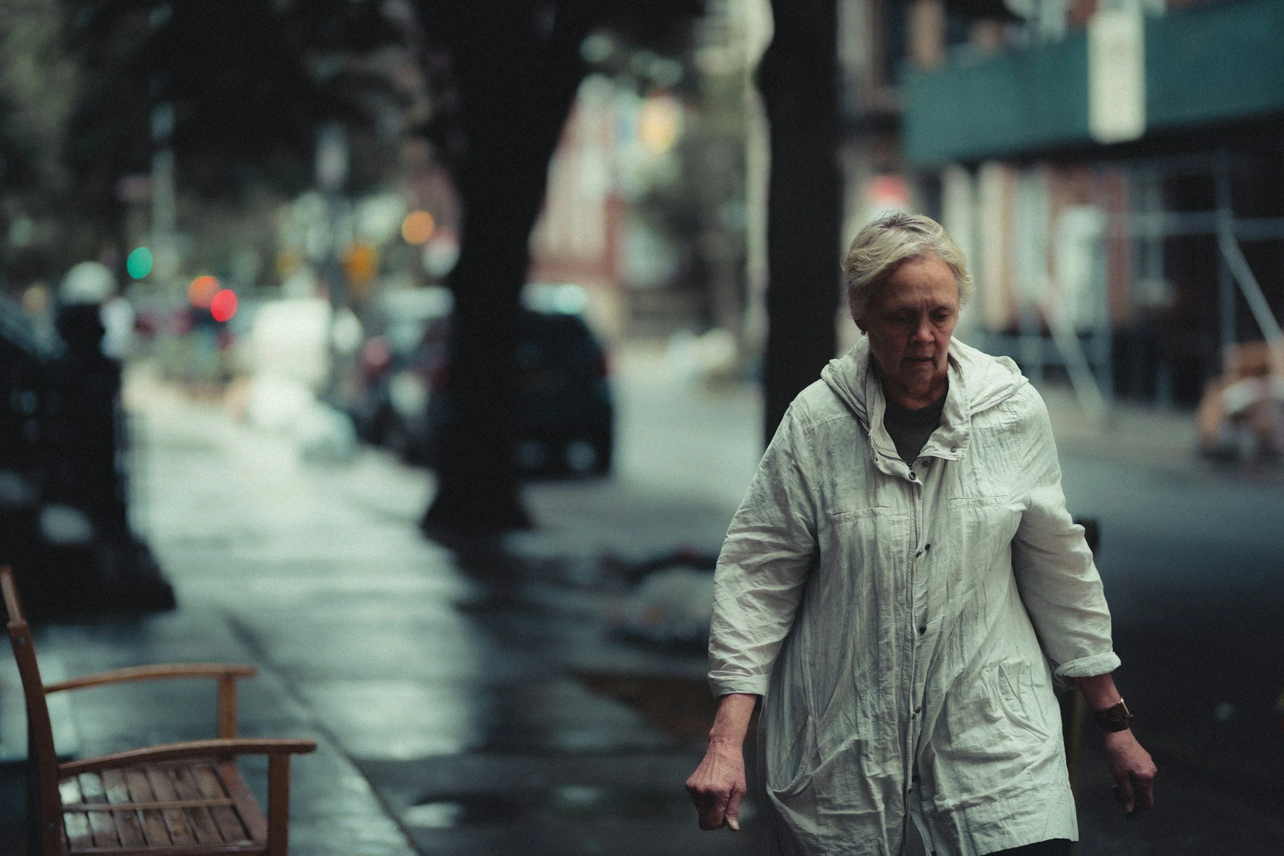 Woman walking alone in the rain, representing grief and loss therapy support in New Jersey