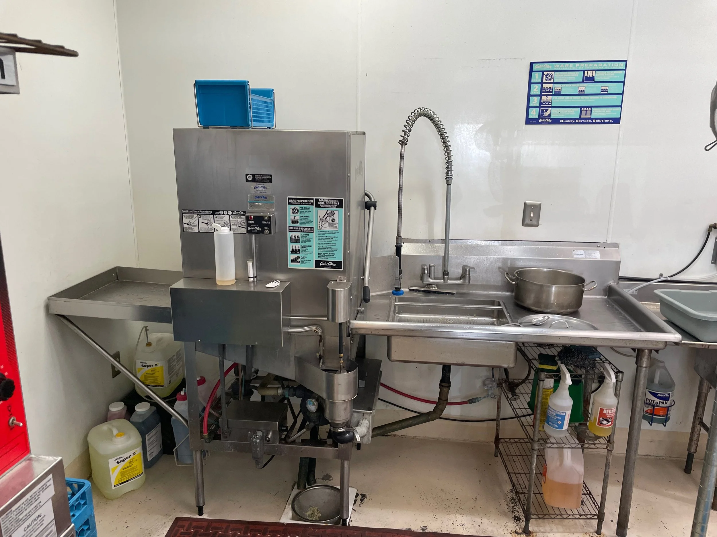 Commercial dishwasher and scullery area in shared Napa kitchen