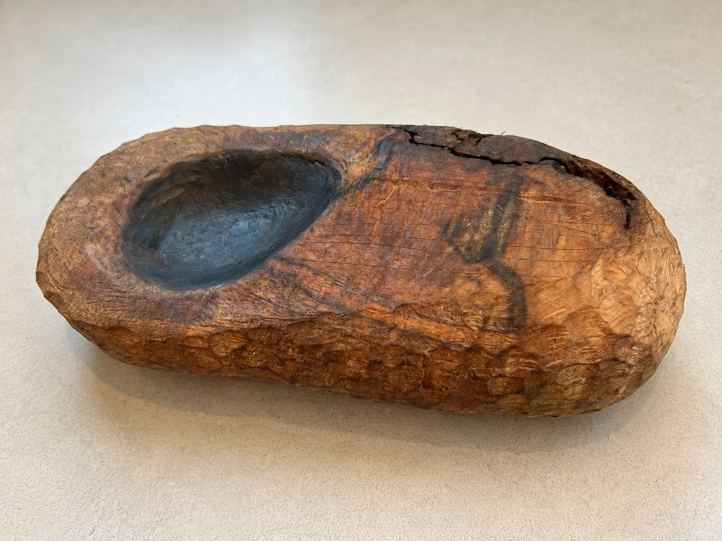 Rustic hand-carved wood vessel with a painted hollow