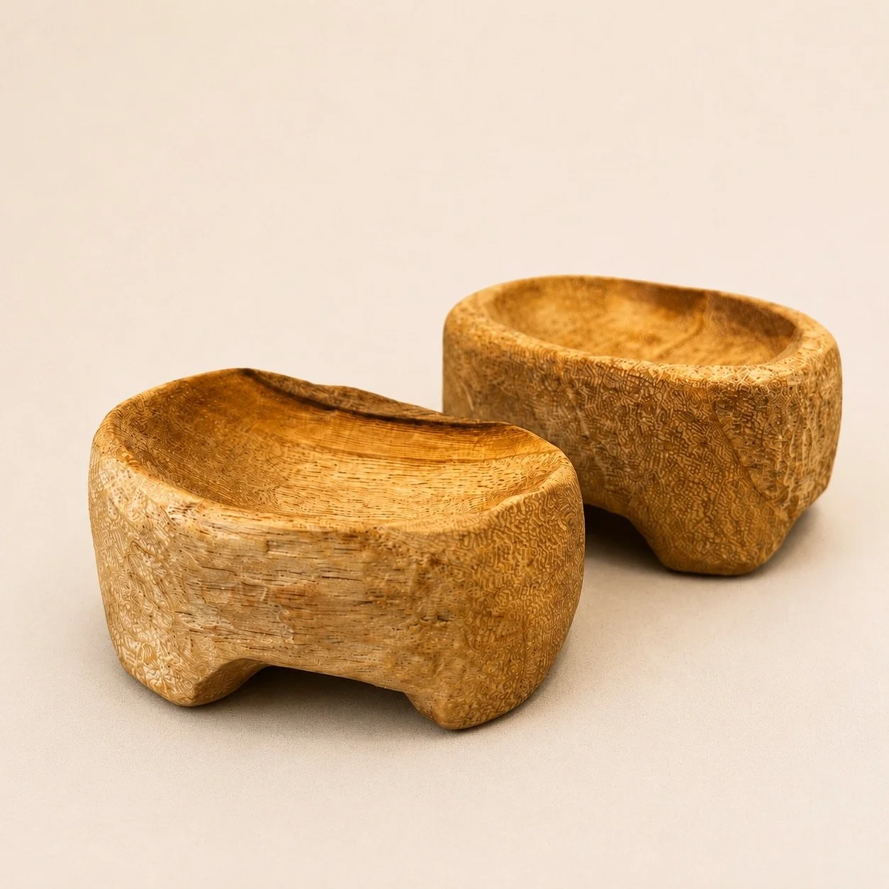 Pair of small hand-carved footed wooden bowls