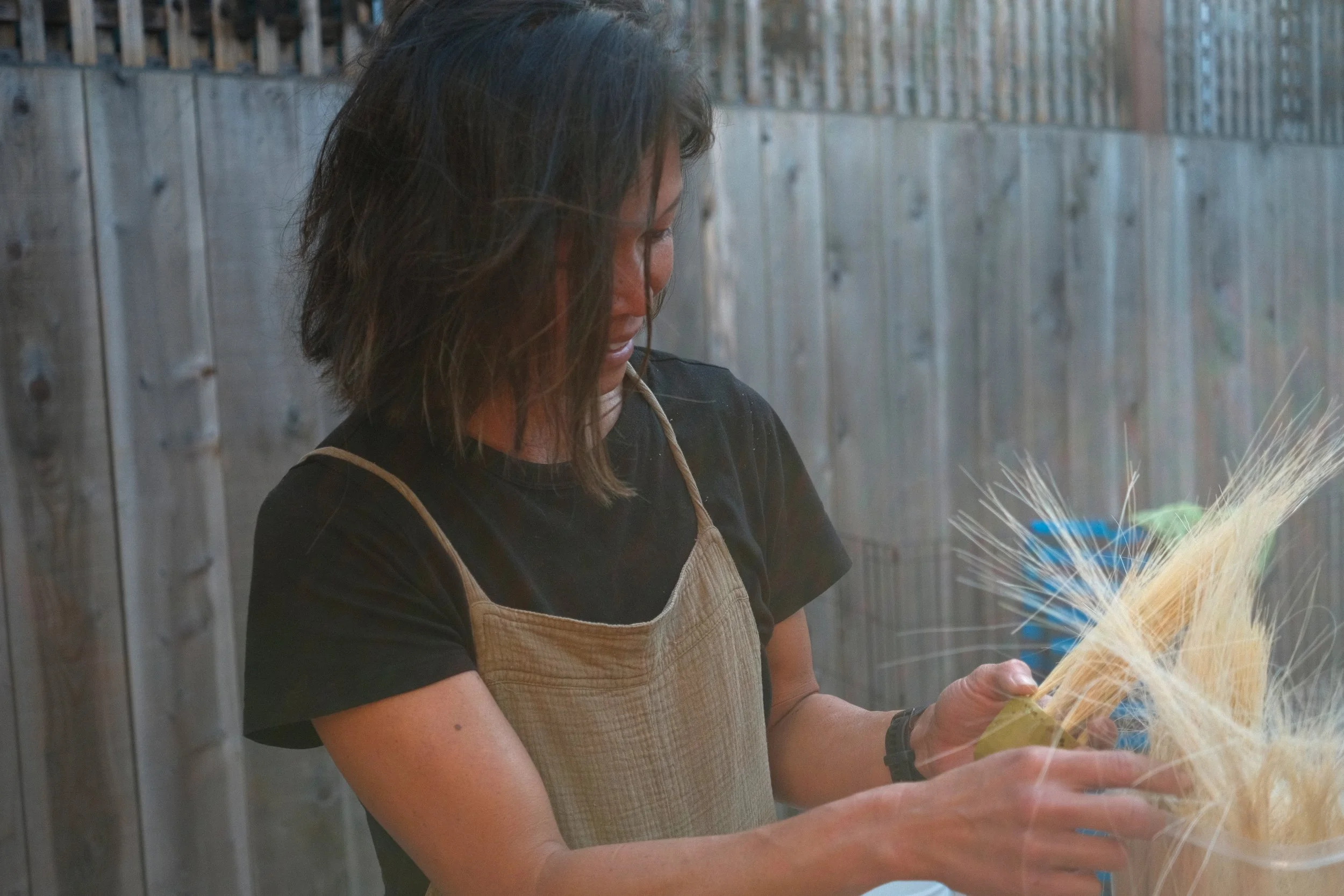Caroline Tien filling a hand-carved brush with tampico fibers