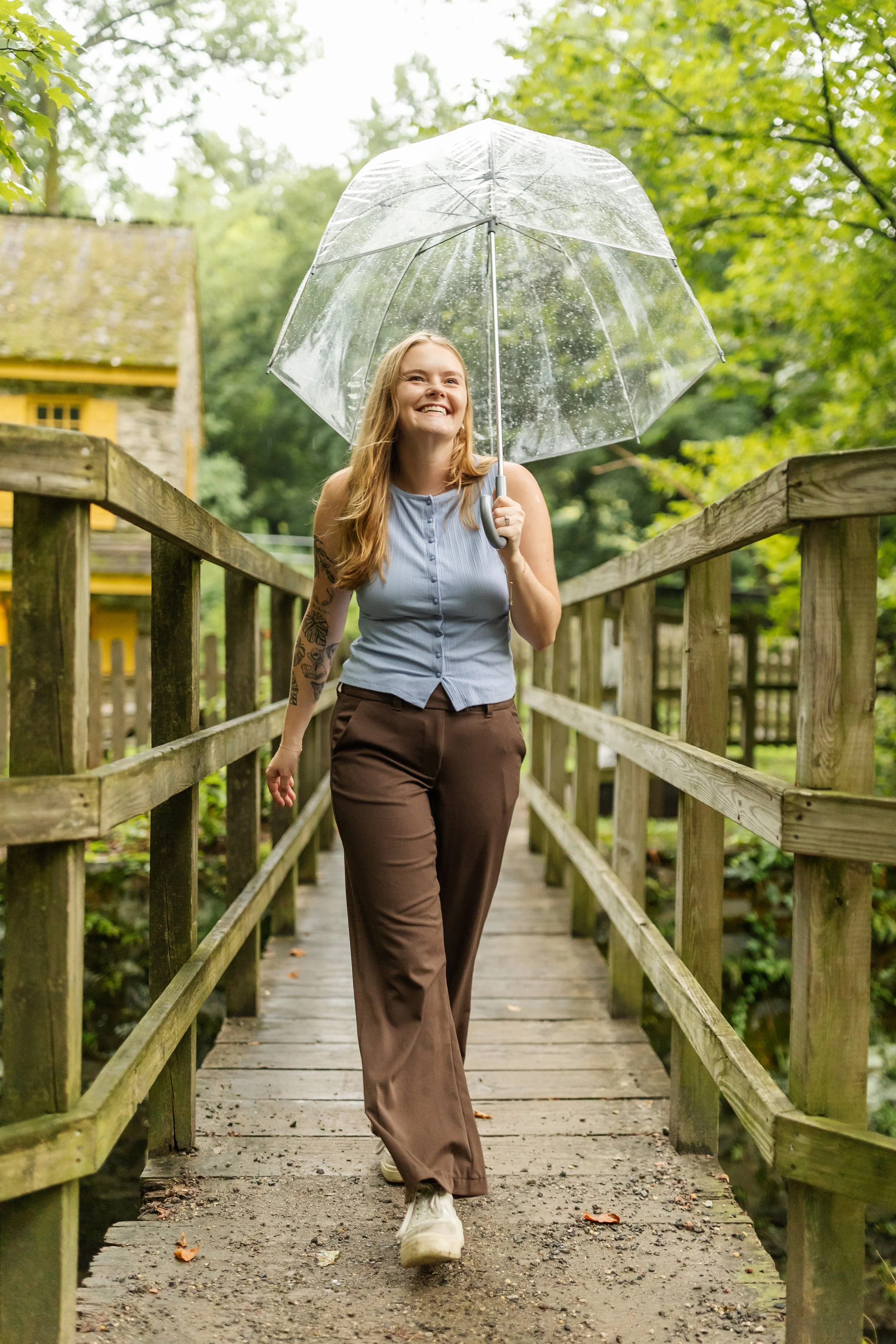 Therapist Natalie Adey walking with an umbrella in professional photo