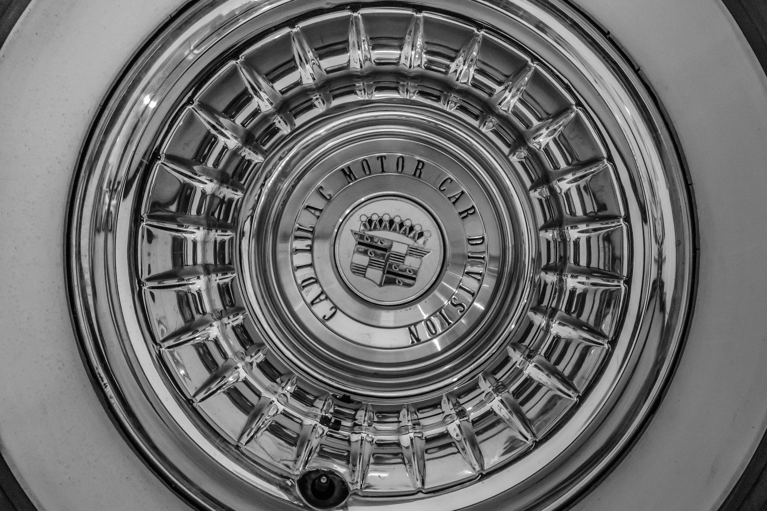 Vintage Cadillac hubcap representing The Cadillac Man, a meaningful Helms Highway mile marker