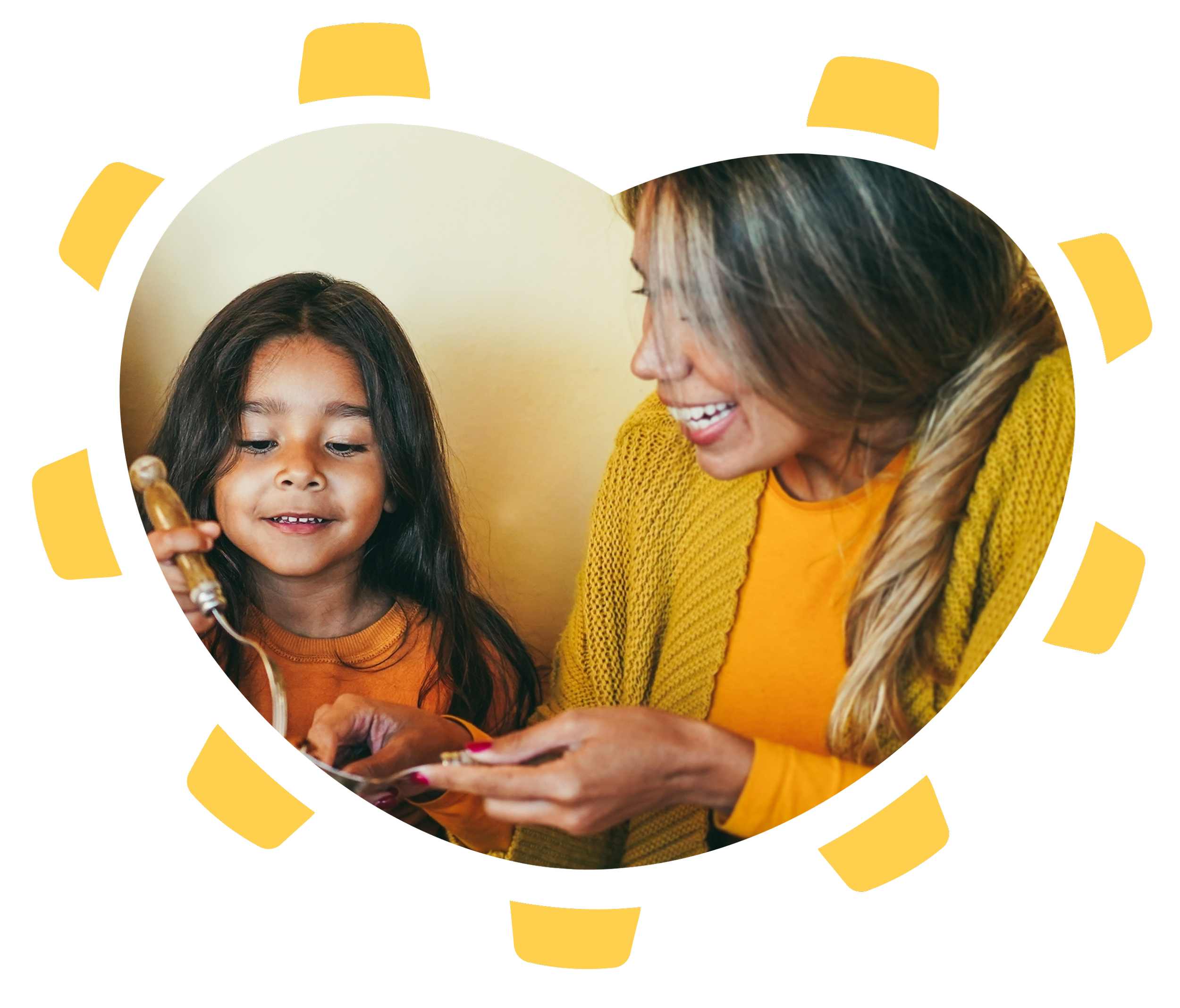 A woman and a girl smiling and looking at a phone together, with the woman showing something on the phone to the girl.