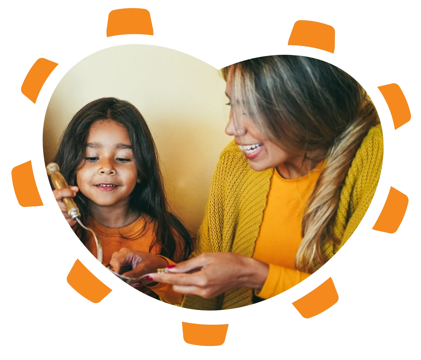 A woman showing a young girl how to use a vintage rotary phone. The girl is holding the receiver, and both are smiling, wearing yellow shirts, in a warm, friendly setting.