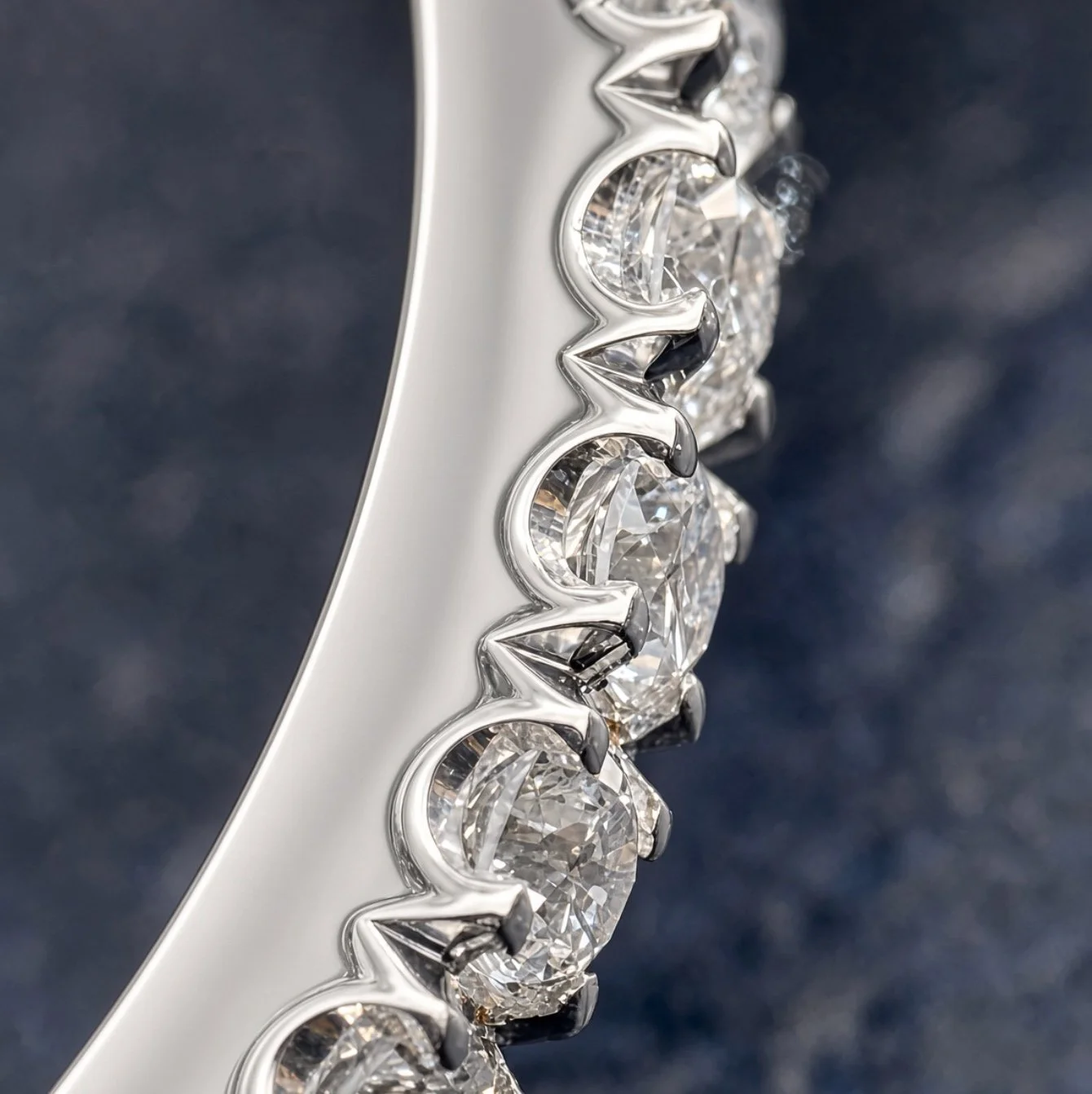 Shared-prong pavé diamonds on a white-gold engagement ring band